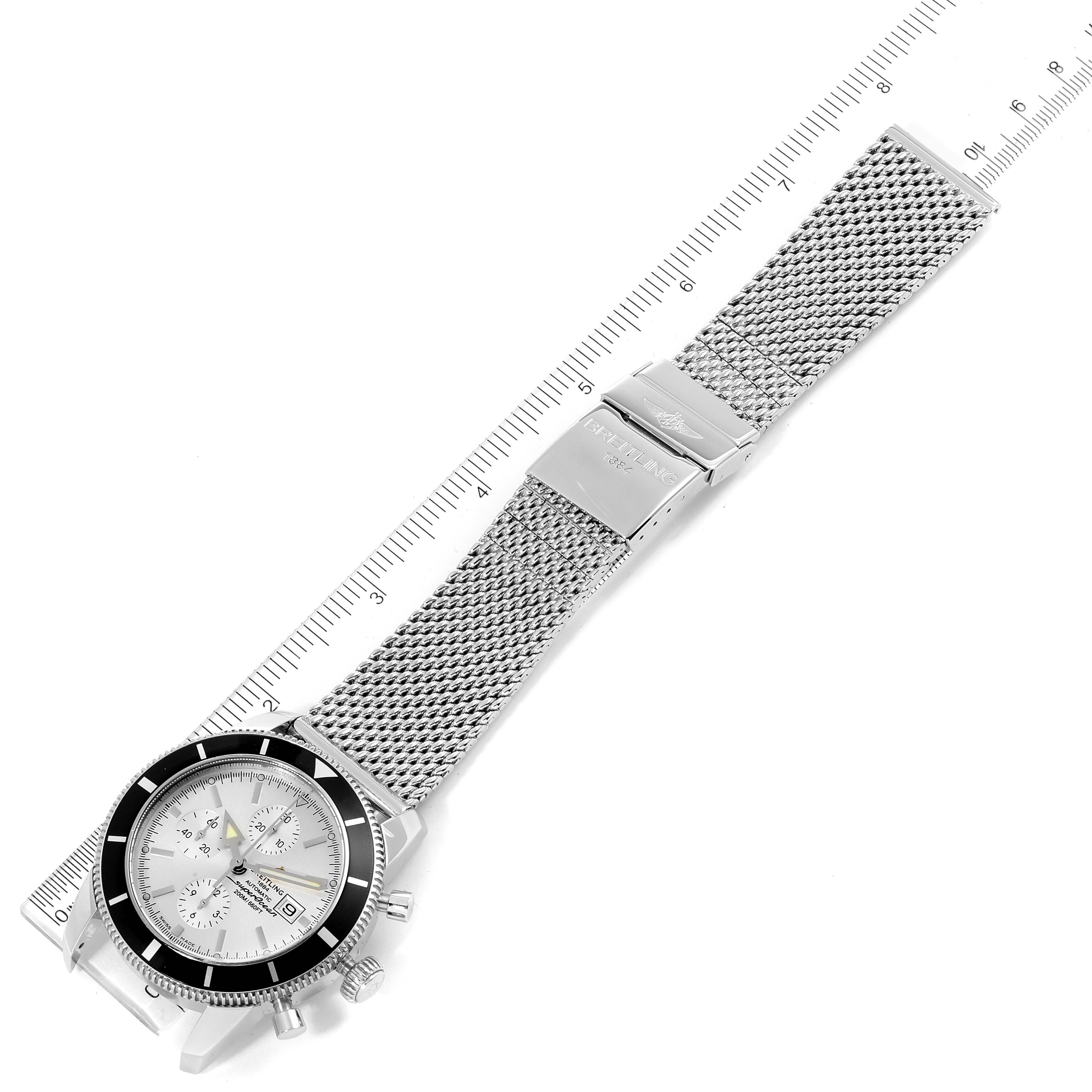 The image shows a Breitling Superocean A13320 Men's Stainless Steel Silver Dial A13320 Men's Stainless Steel Silver Dial watch from an overhead angle, displaying the dial, bezel, and stainless steel mesh bracelet fully extended.