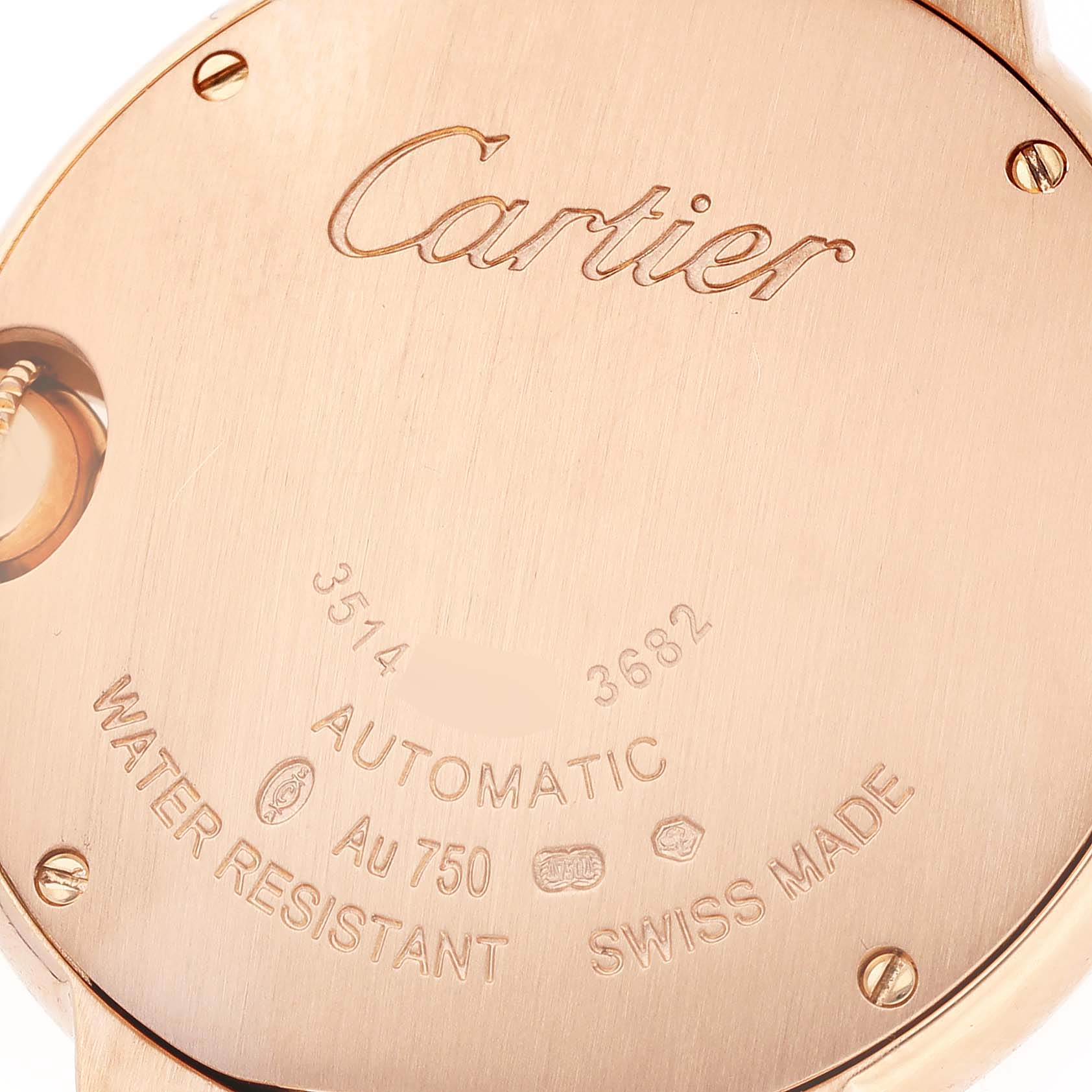 The image shows the back case of a Ballon Bleu model by Cartier, highlighting engravings and screw details.