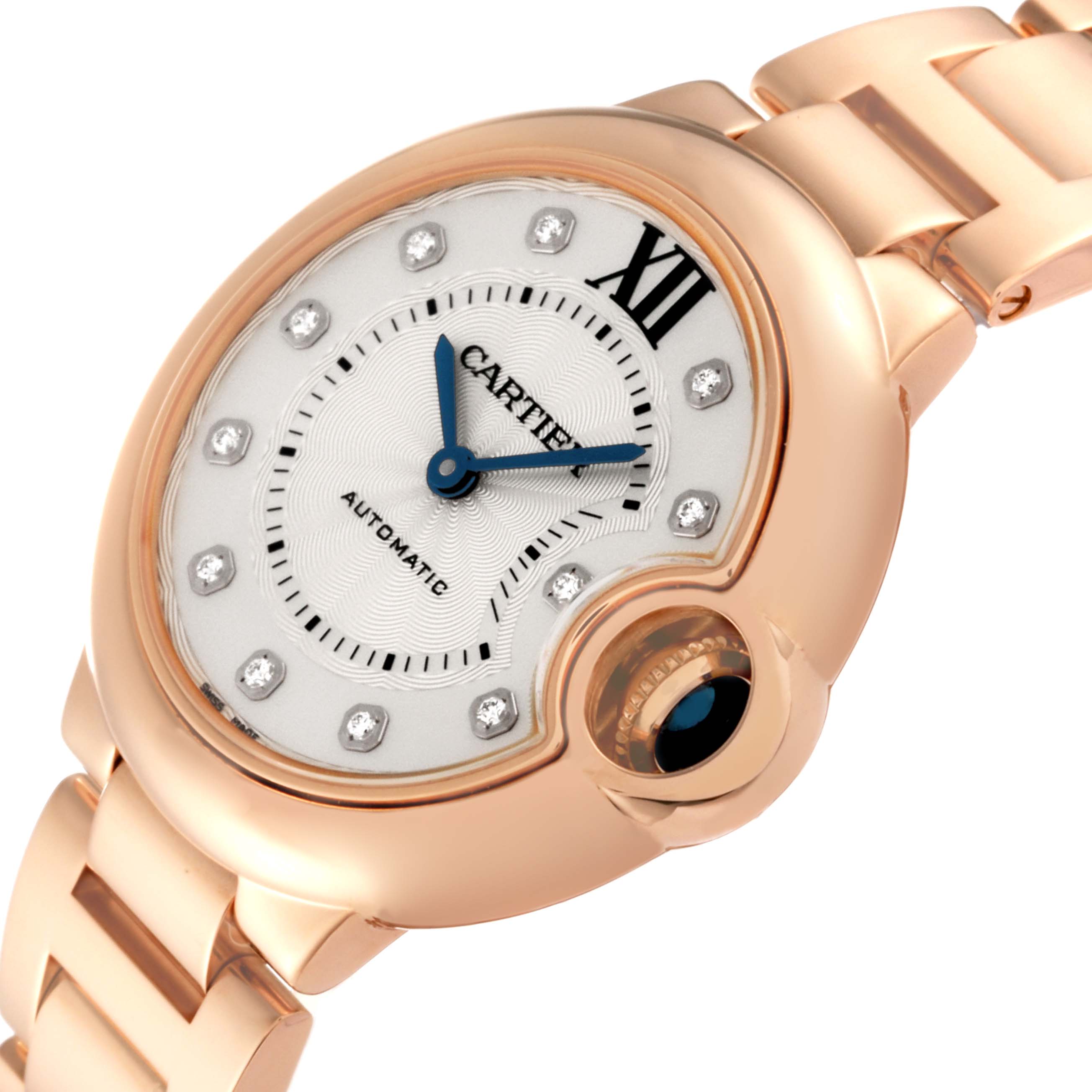 The image shows a close-up angle of the Cartier Ballon Bleu WE902062 Women's Rose Gold Silver Dial WE902062 Women's Rose Gold Silver Dial watch, highlighting its face, blue hands, diamond markers, and gold bracelet.