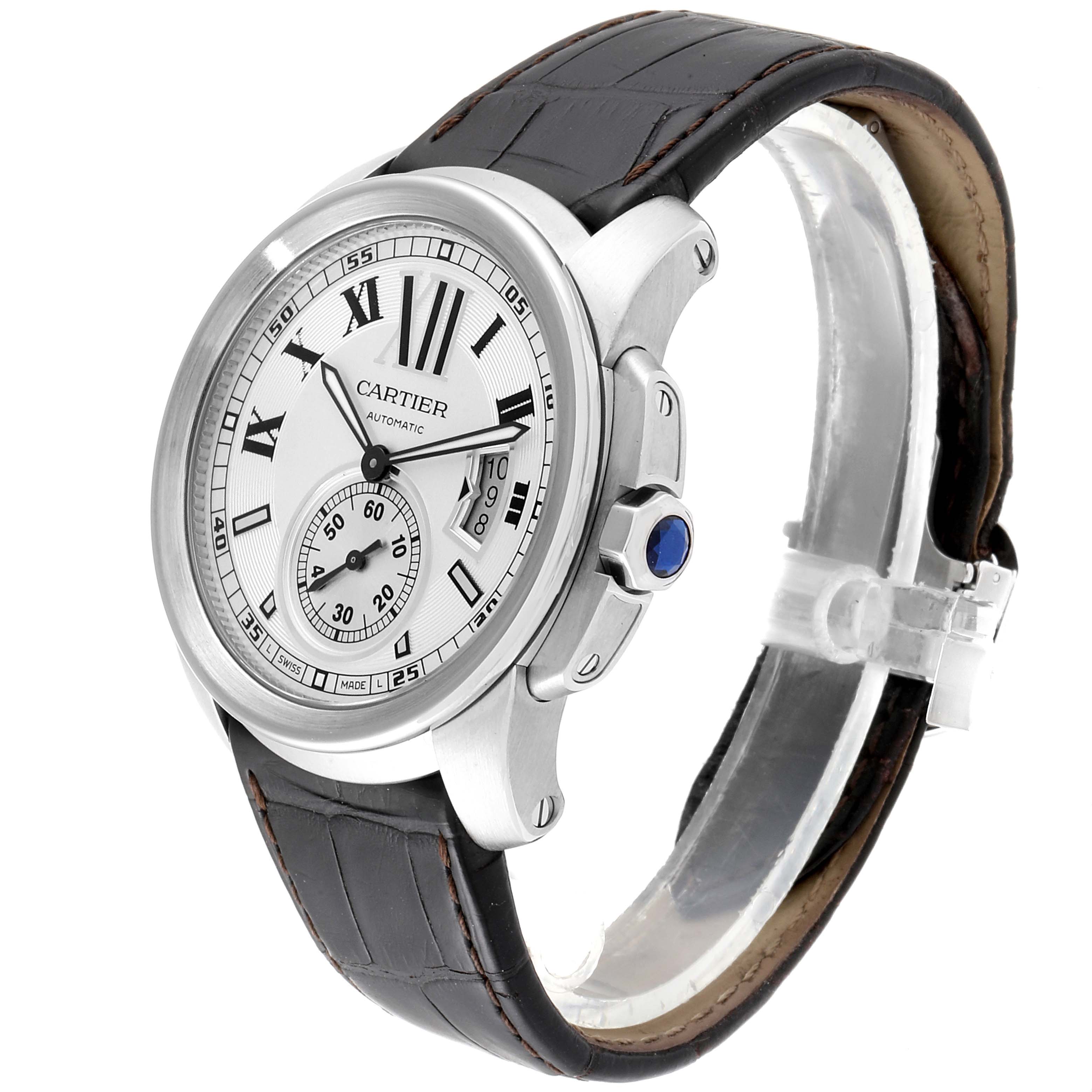 The image shows a Calibre de Cartier watch by Cartier from a front and slight side angle, highlighting its dial, case, and strap.