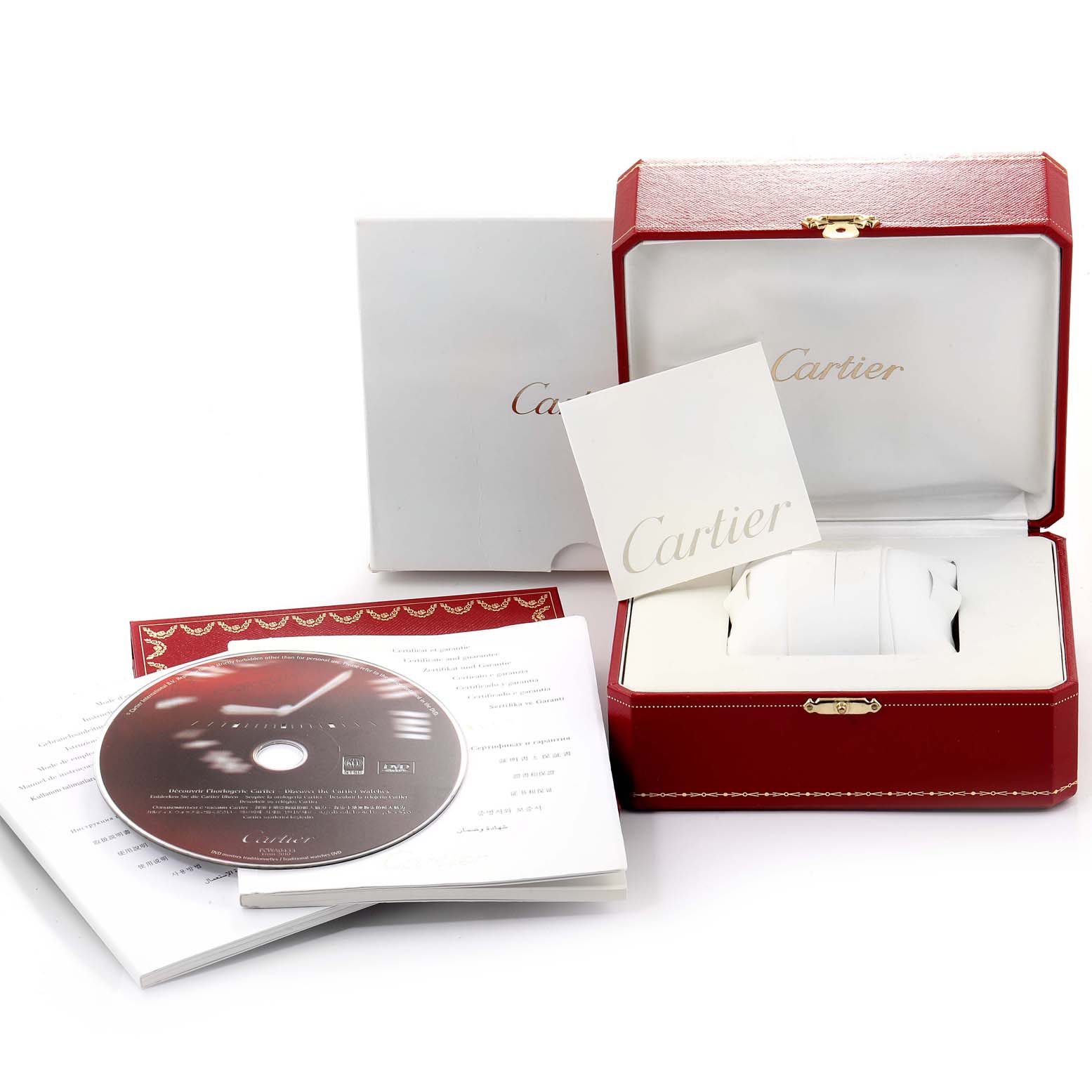 The image shows packaging and accessories for the Calibre de Cartier watch, including a box, manual, and a CD, viewed from the front.