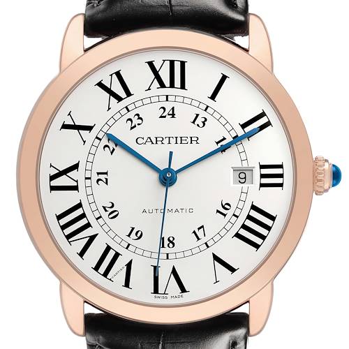 The Ronde model by Cartier is shown from the front, displaying its face with Roman numerals, hands, and crown with a blue cabochon.