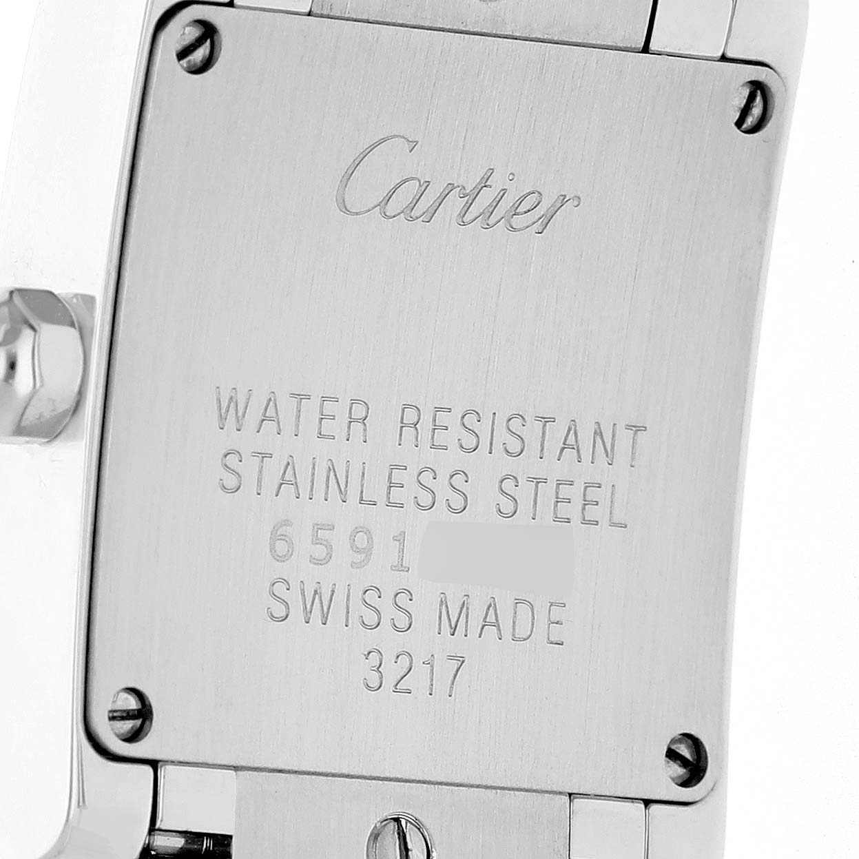 The image shows the back case of a Cartier Tank Française watch with engraved details.
