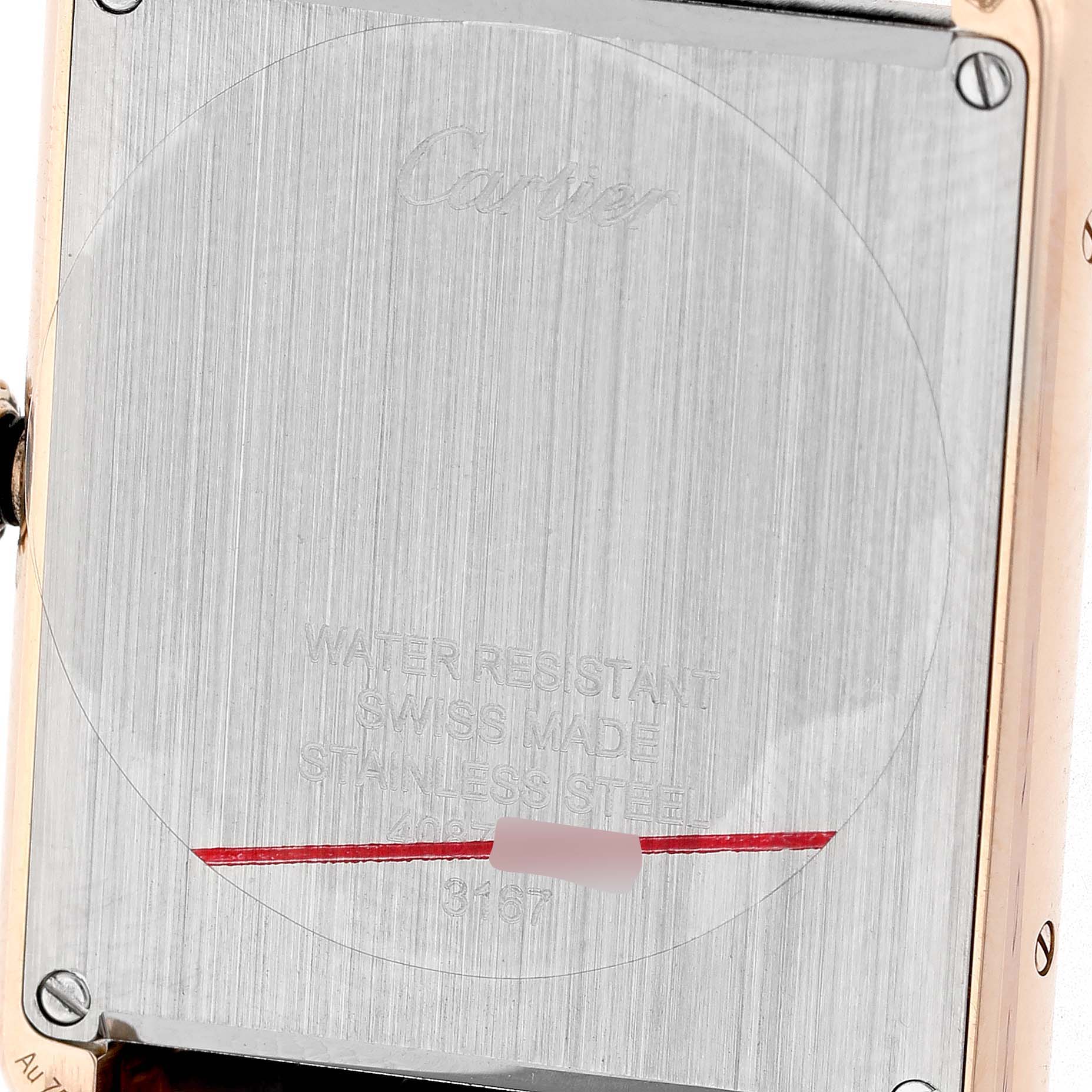 The image shows the back of a Cartier Tank Solo W5200025 Men's Rose Gold Silver Dial watch, highlighting its stainless steel case and engraved details.