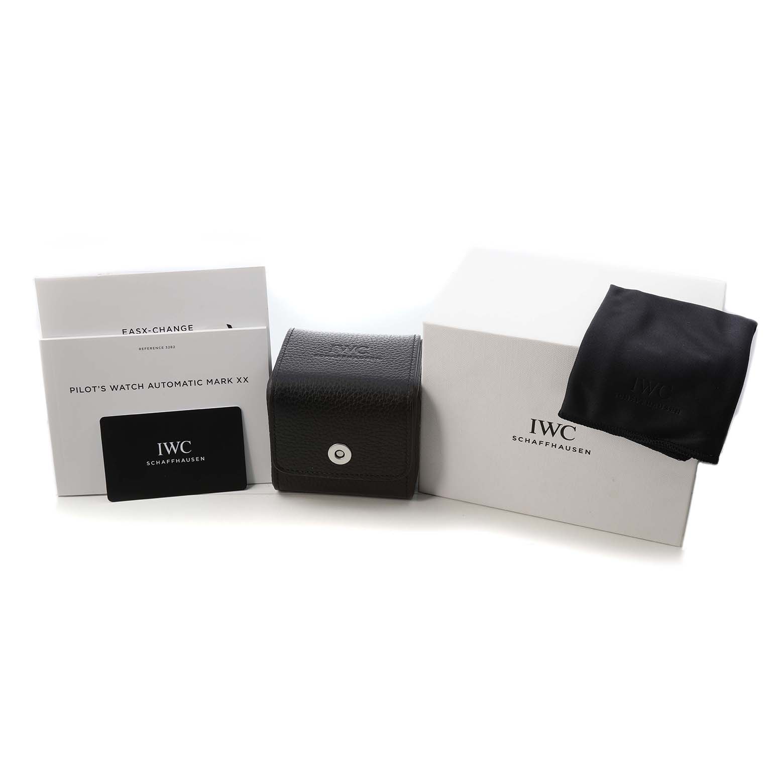 The image shows accessories for the IWC Pilot IW328201 Men's Stainless Steel Black Dial's Watch, including a box, leather case, cloth, and documents.