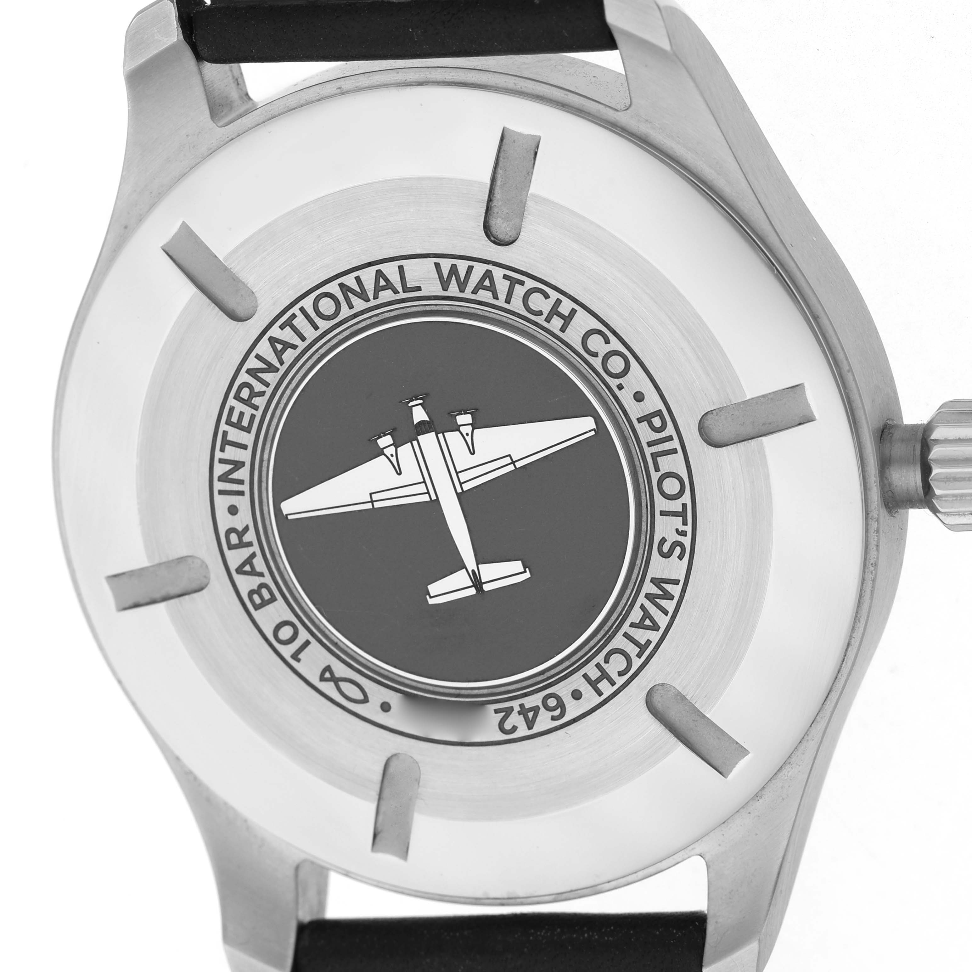 The image shows the back case of the IWC Pilot IW328201 Men's Stainless Steel Black Dial model watch, featuring branding and an engraved airplane design.