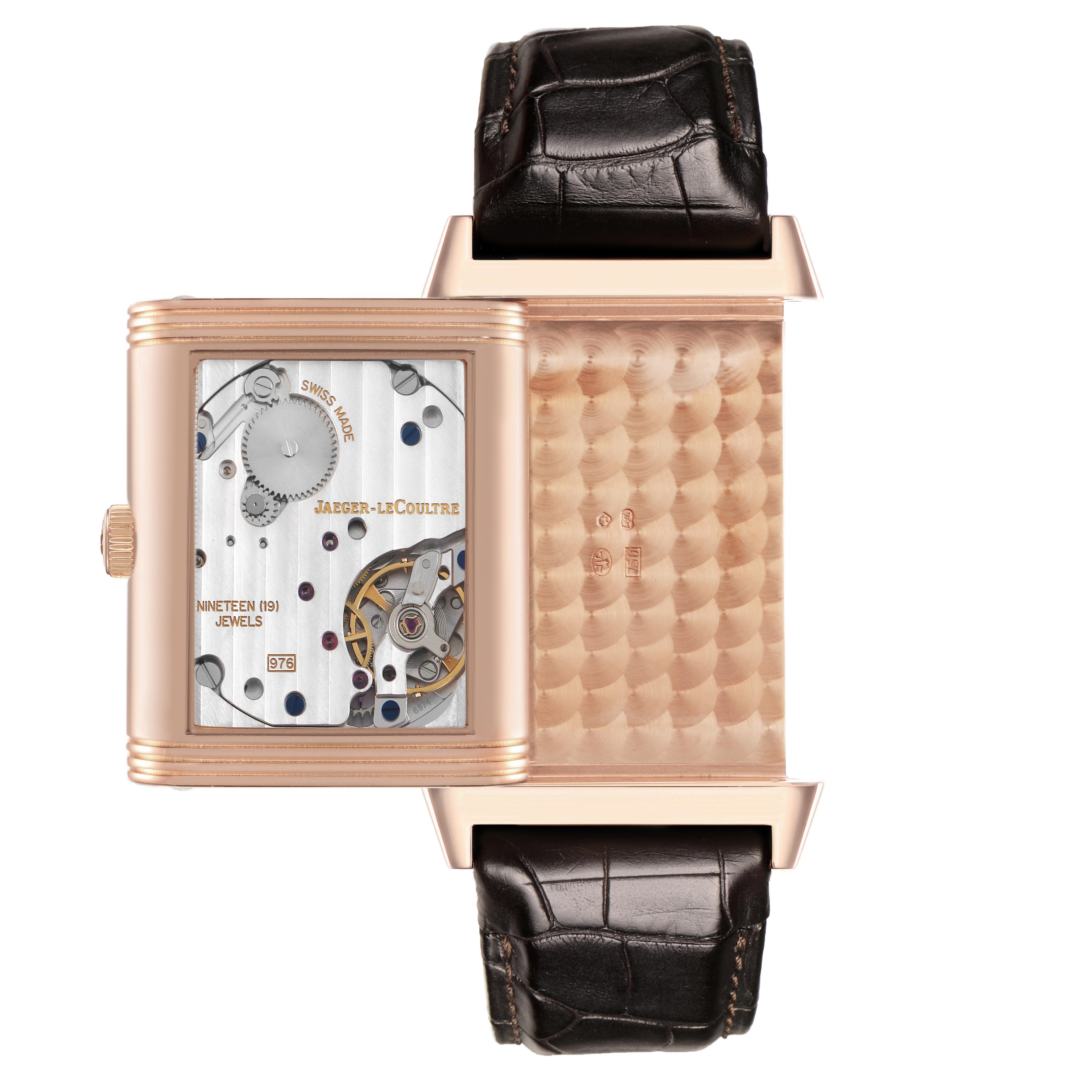 The Jaeger LeCoultre Reverso Q3732420 Men's Rose Gold Silver Dial Q3732420 Men's Rose Gold Silver Dial watch is shown with its case flipped, exposing the movement and inner details.