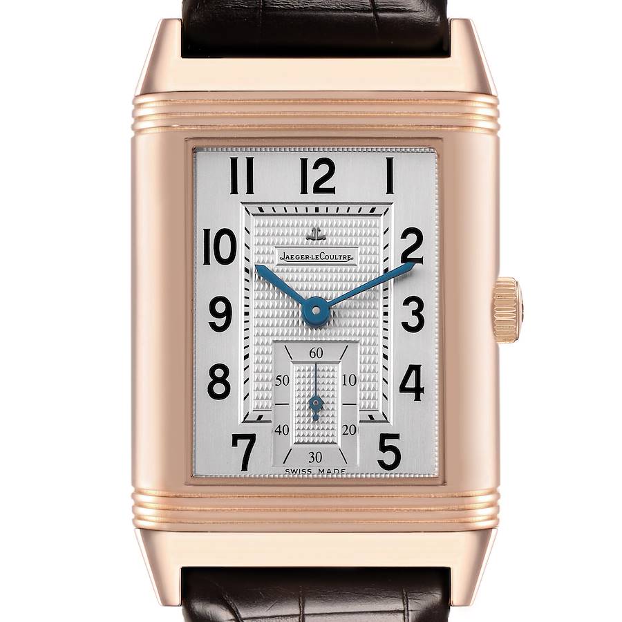 The Jaeger LeCoultre Reverso watch is shown from the front, highlighting the rectangular dial and crown on the right.
