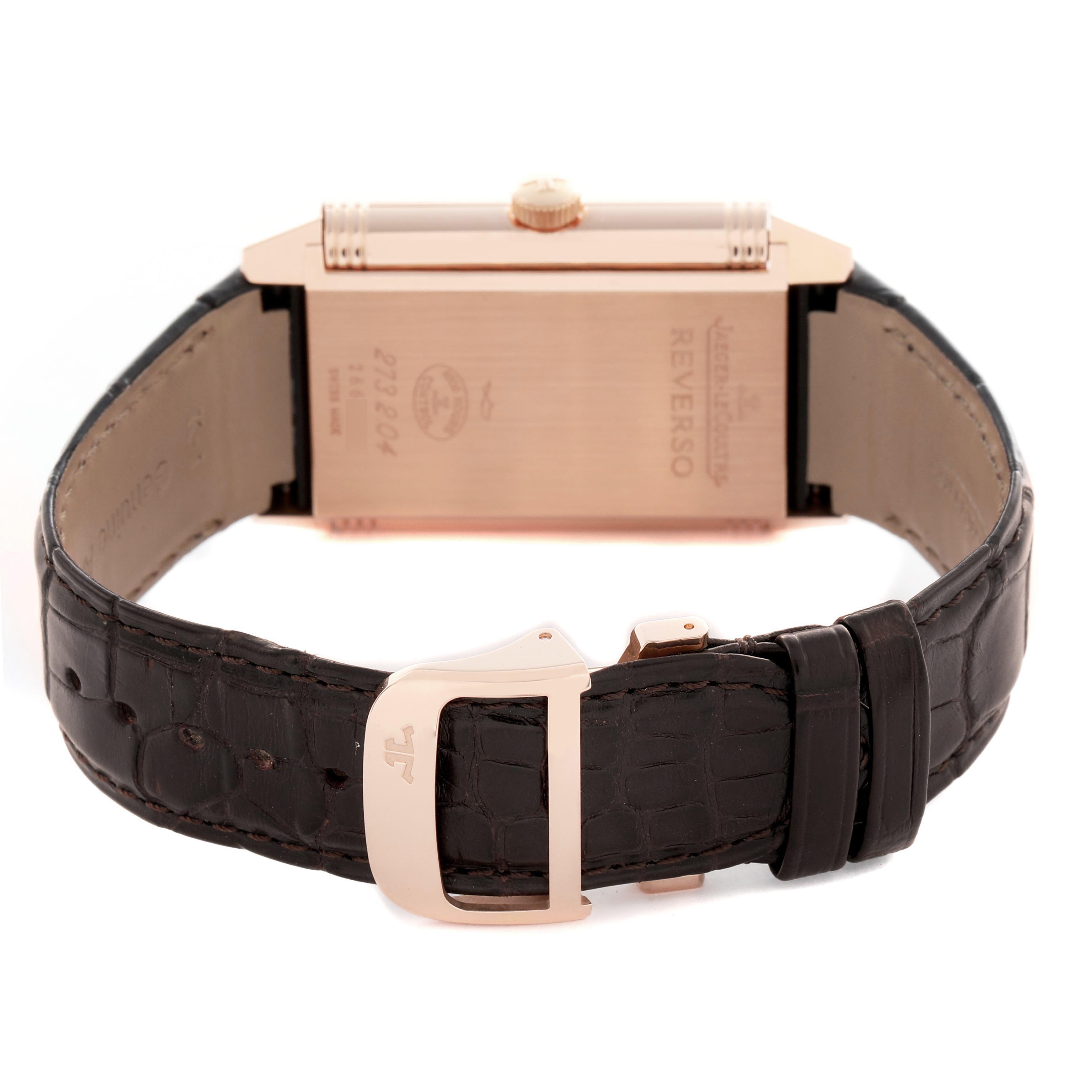 The image shows the back and side view of a Jaeger-LeCoultre Reverso watch, highlighting the case, crown, and leather strap.