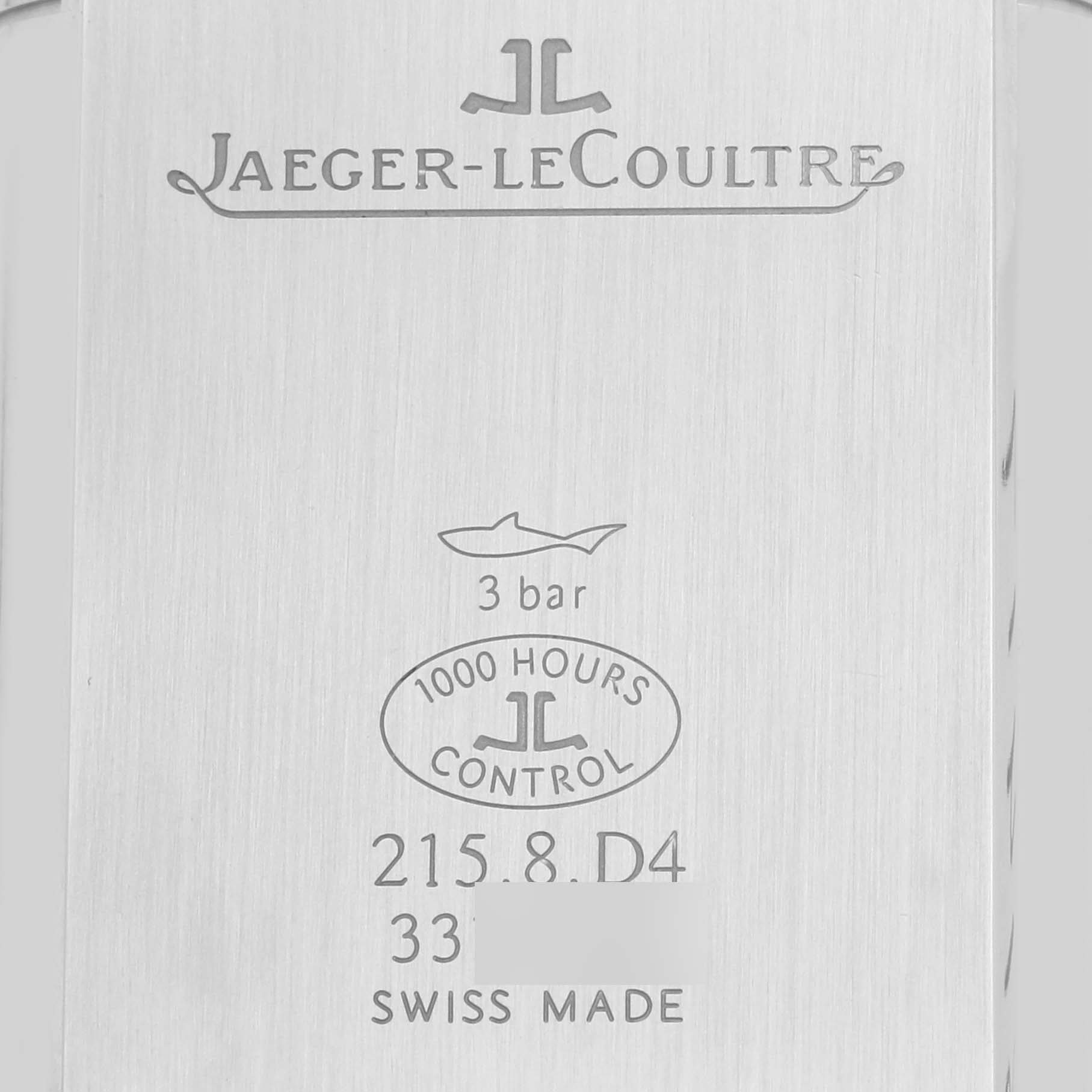 The image shows the engraved back case of a Reverso model watch by Jaeger-LeCoultre, displaying its specifications and branding.