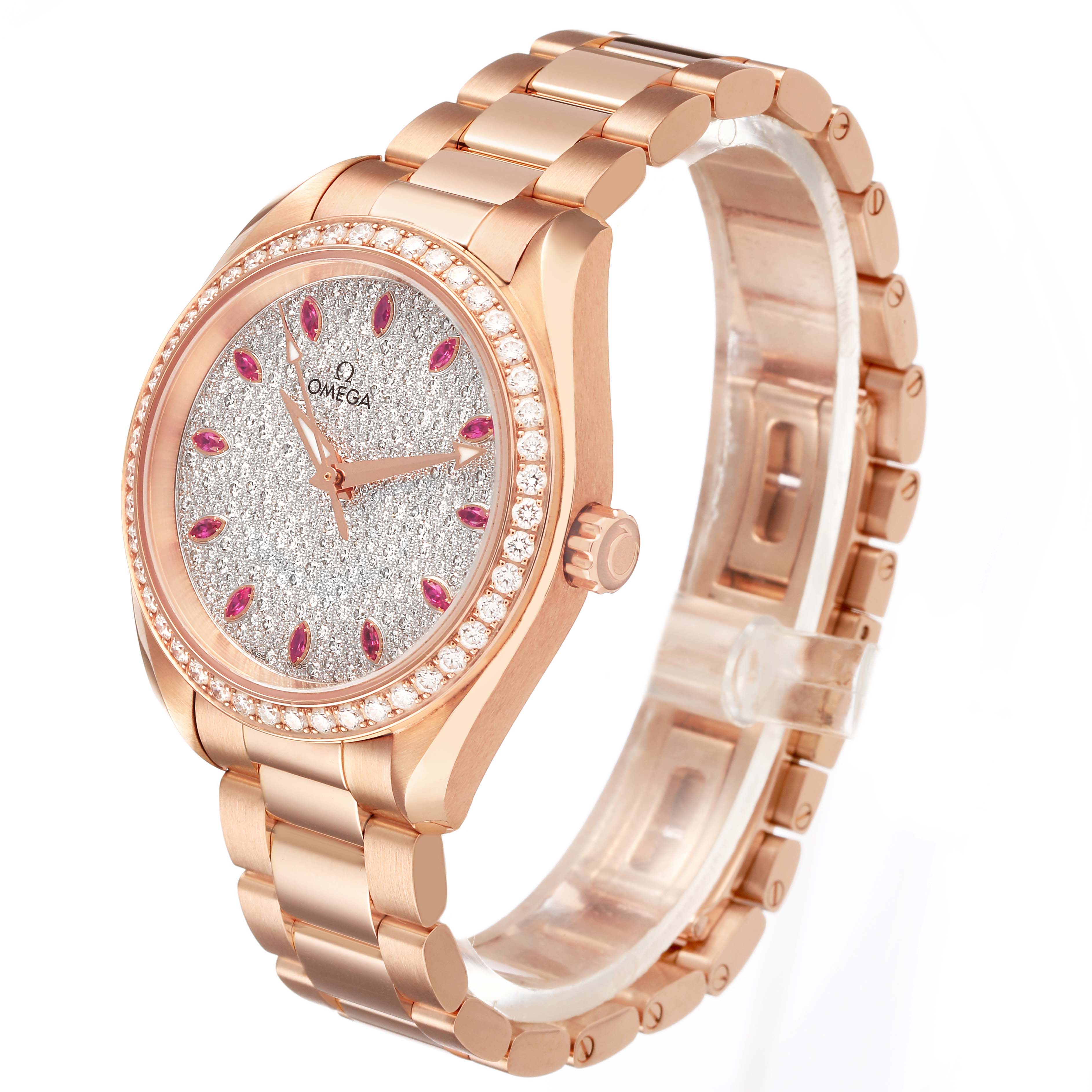The Omega 231.15.34.20.55.002 Women's Rose Gold Silver Dial Aqua Terra 34 Rose Gold Diamond Ruby Ladies watch is shown at a three-quarter angle, highlighting the face, bezel, and bracelet.
