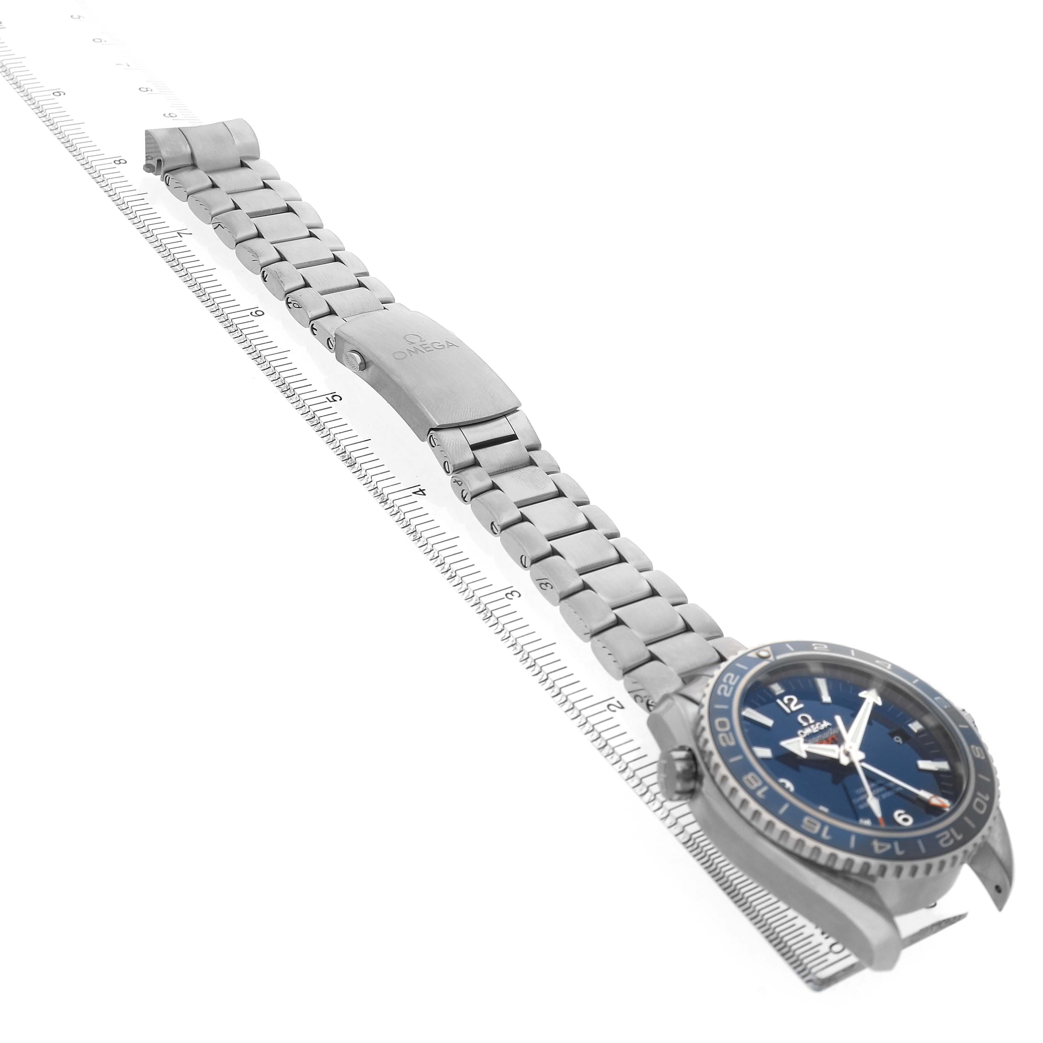 The Omega Planet Ocean 232.90.44.22.03.001 Men's Titanium Blue Dial watch is photographed from a side angle, displaying its face, bezel, bracelet, and clasp.