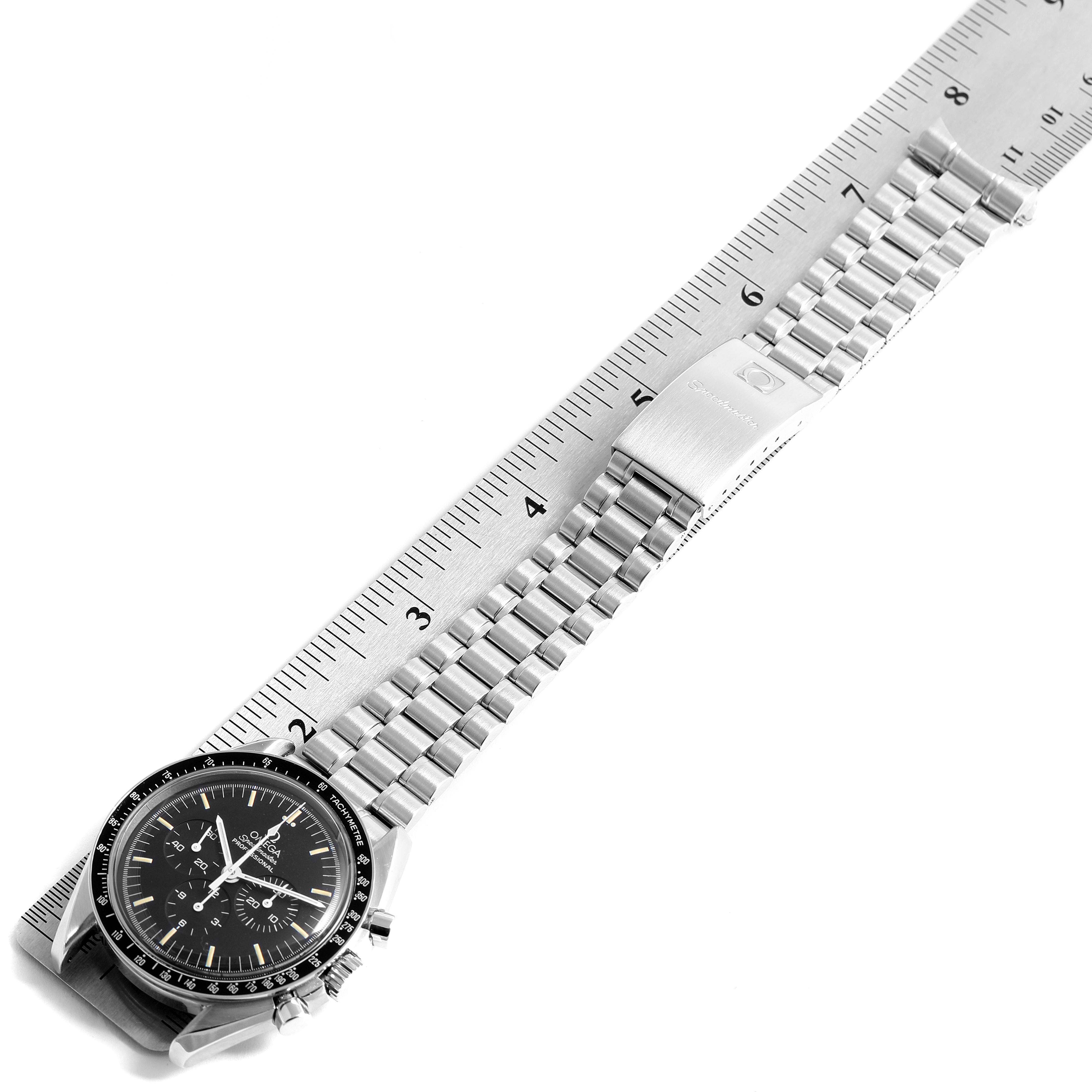 The Omega Speedmaster 3590.50.00 Men's Stainless Steel Black Dial 3590.50.00 Men's Stainless Steel Black Dial watch is shown laid flat with its metal bracelet fully extended above a ruler for measurement.