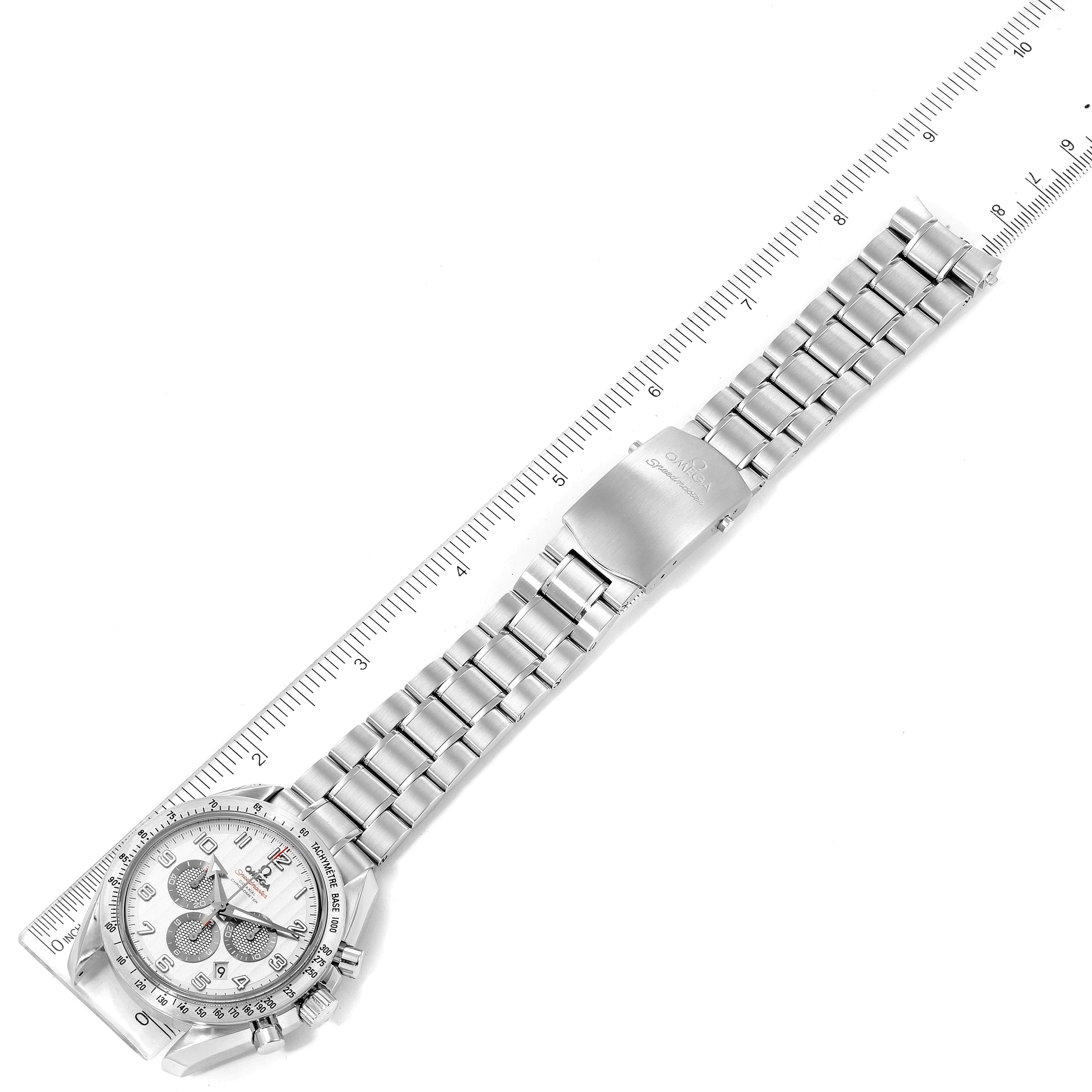 The Omega Speedmaster 321.10.44.50.02.001 Men's Stainless Steel Silver Dial watch is shown flat, displaying the face, bracelet, and clasp next to a ruler for scale.