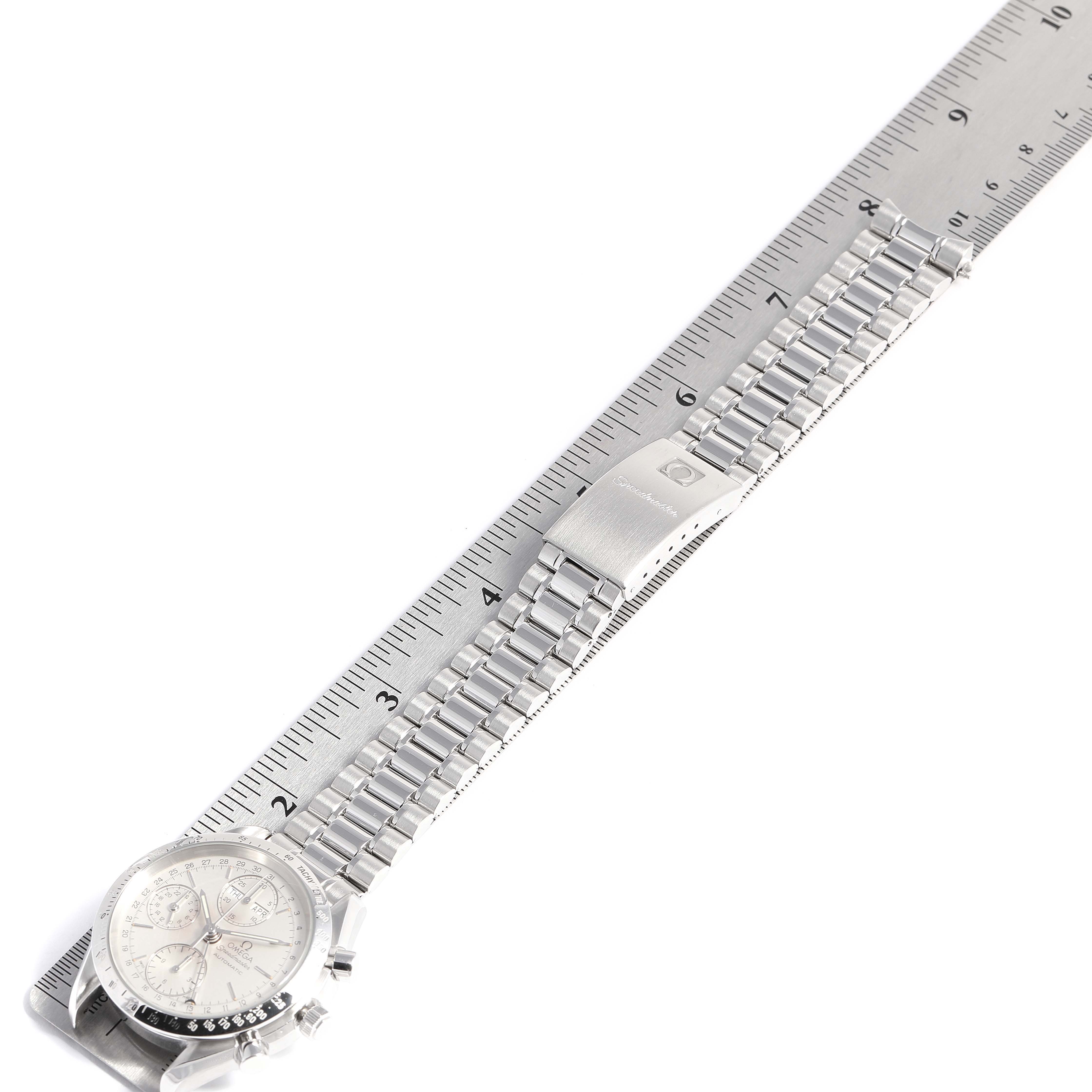 This image shows an Omega Speedmaster 3521.30.00 Men's Stainless Steel Silver Dial 3521.30.00 Men's Stainless Steel Silver Dial watch from a top-down angle, with the dial, bracelet, and clasp clearly visible alongside a ruler.