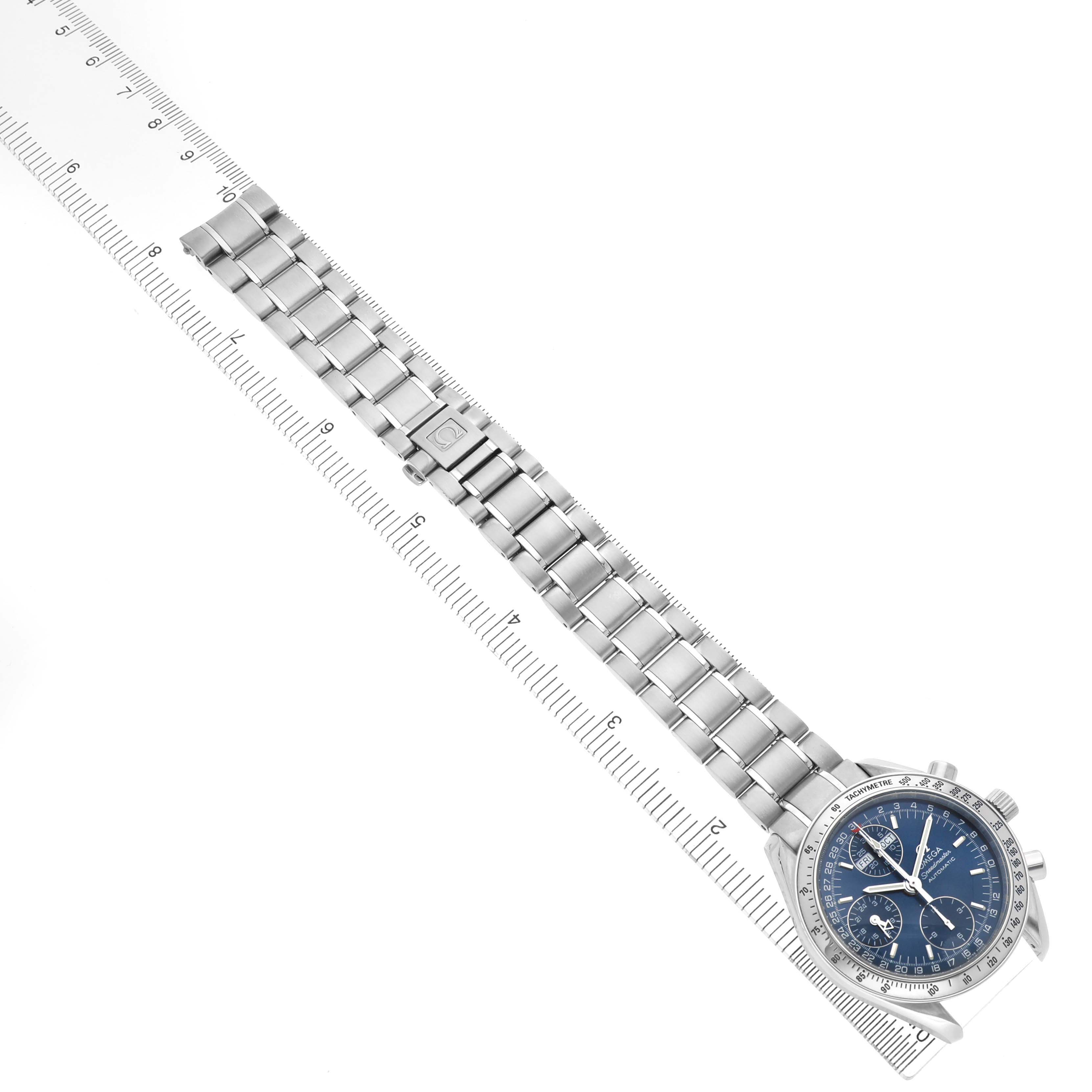 The Omega Speedmaster 3523.80.00 Men's Stainless Steel Blue Dial watch is shown from a top-down angle, highlighting the face, bracelet, and clasp, along with a measuring ruler.