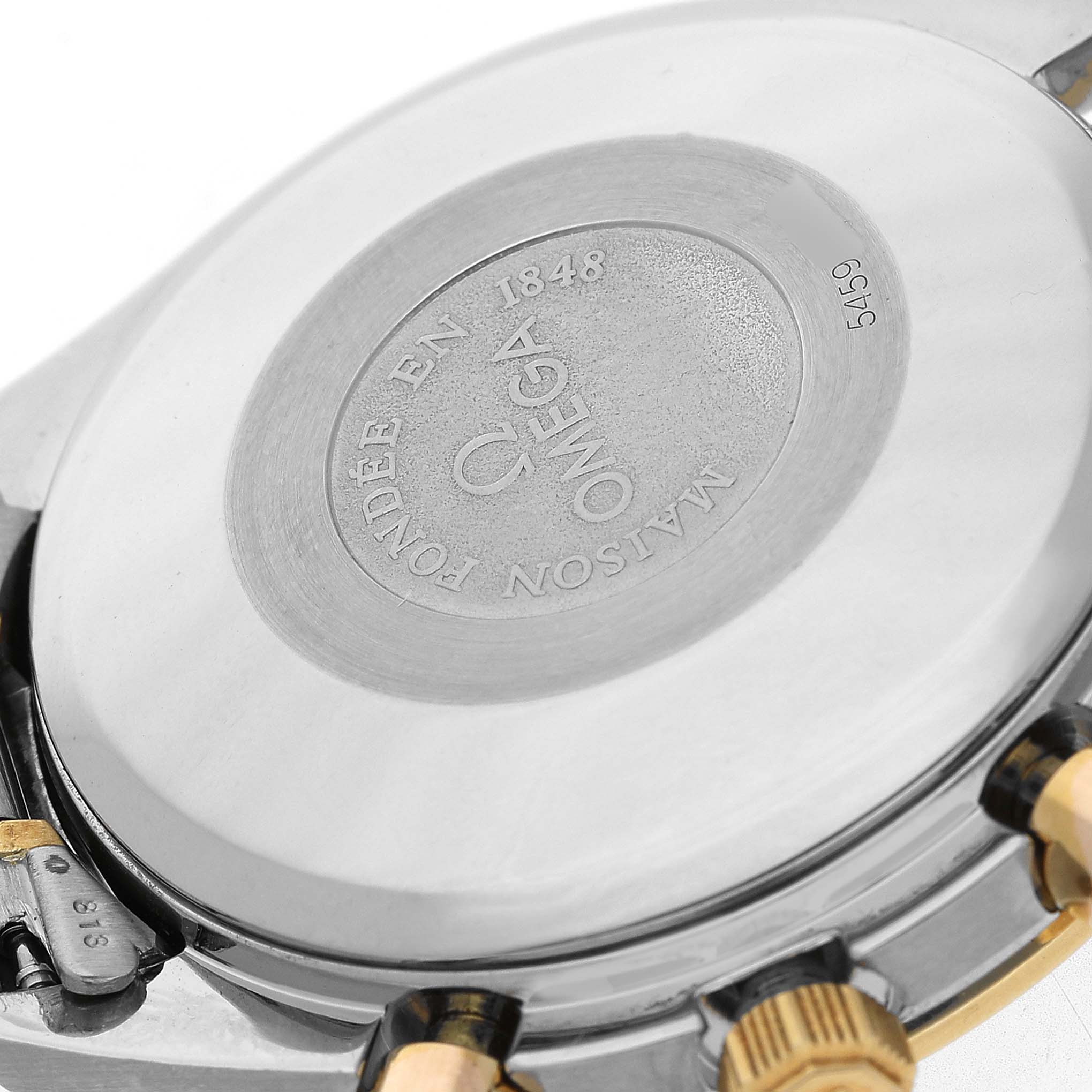 The image shows the case back of an Omega Speedmaster 3321.80.00 Men's Steel and Gold (two tone) Blue Dial watch, featuring engraved branding and a side view of the pushers.