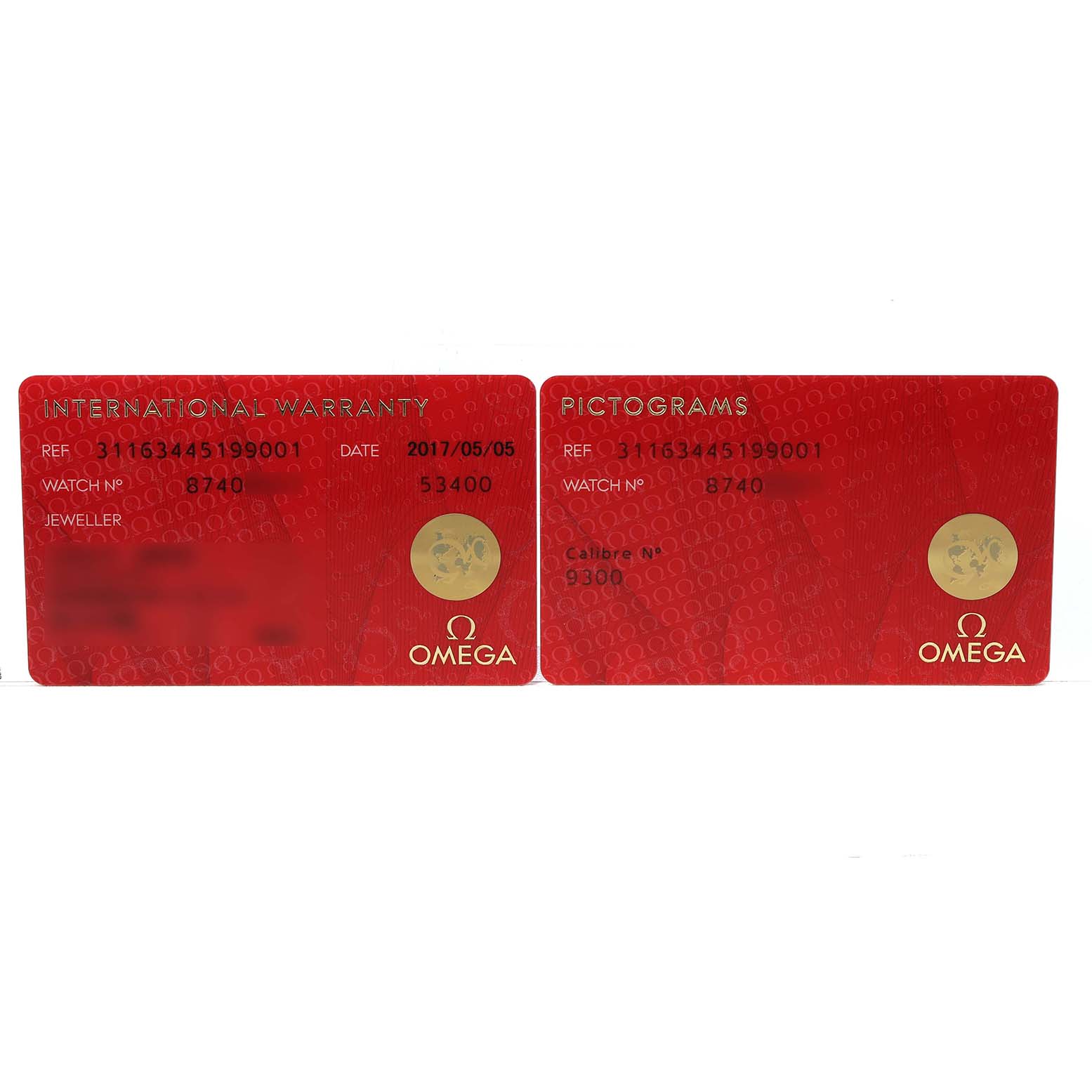 The image shows two red Omega Speedmaster 311.63.44.51.99.001 Men's Ceramic Grey Dial warranty and pictogram cards, displaying reference and watch numbers.