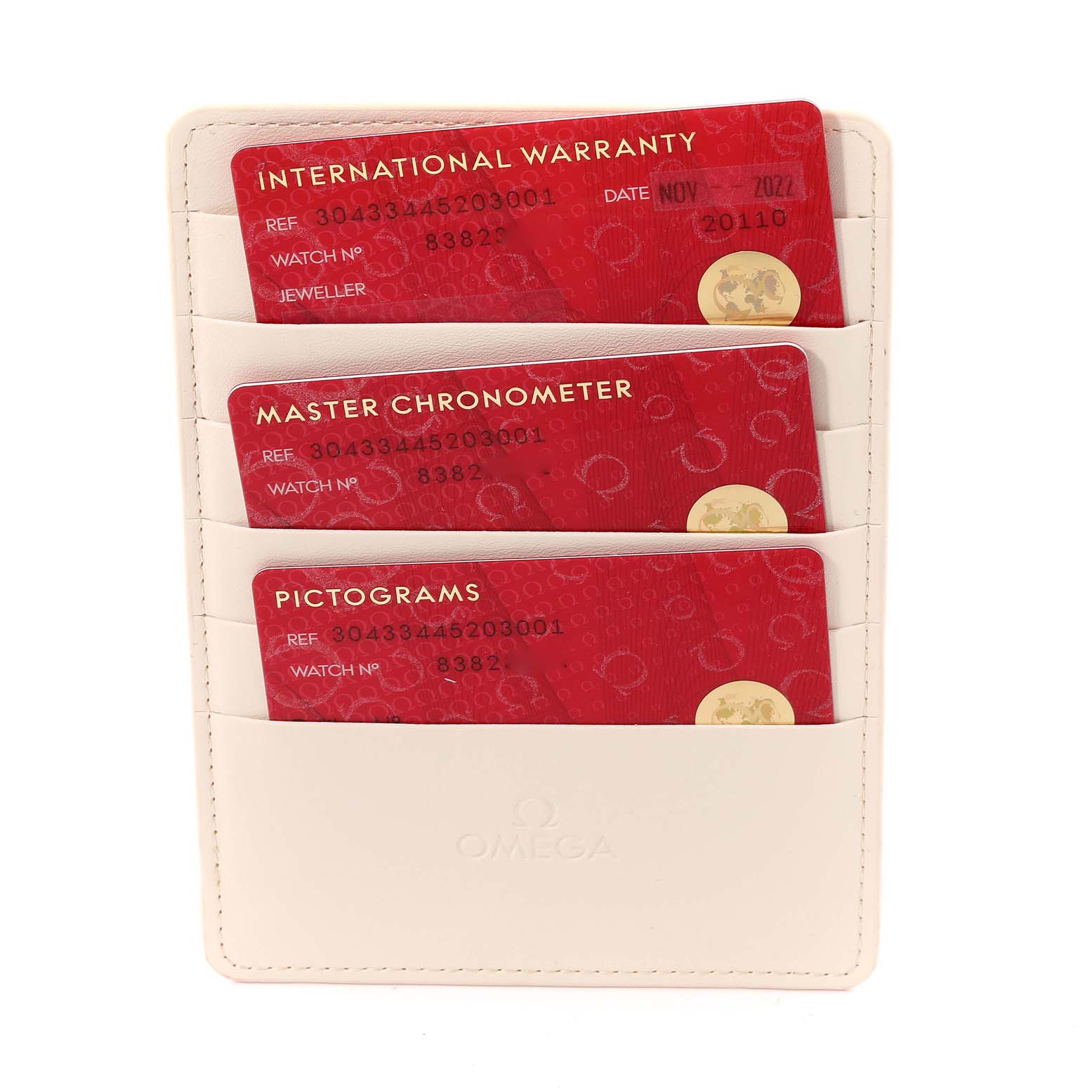 The image shows warranty cards for the Omega Speedmaster 304.33.44.52.03.001 Men
s Stainless Steel Blue Dial 304.33.44.52.03.001 Men
s Stainless Steel Blue Dial, displayed in a white cardholder.