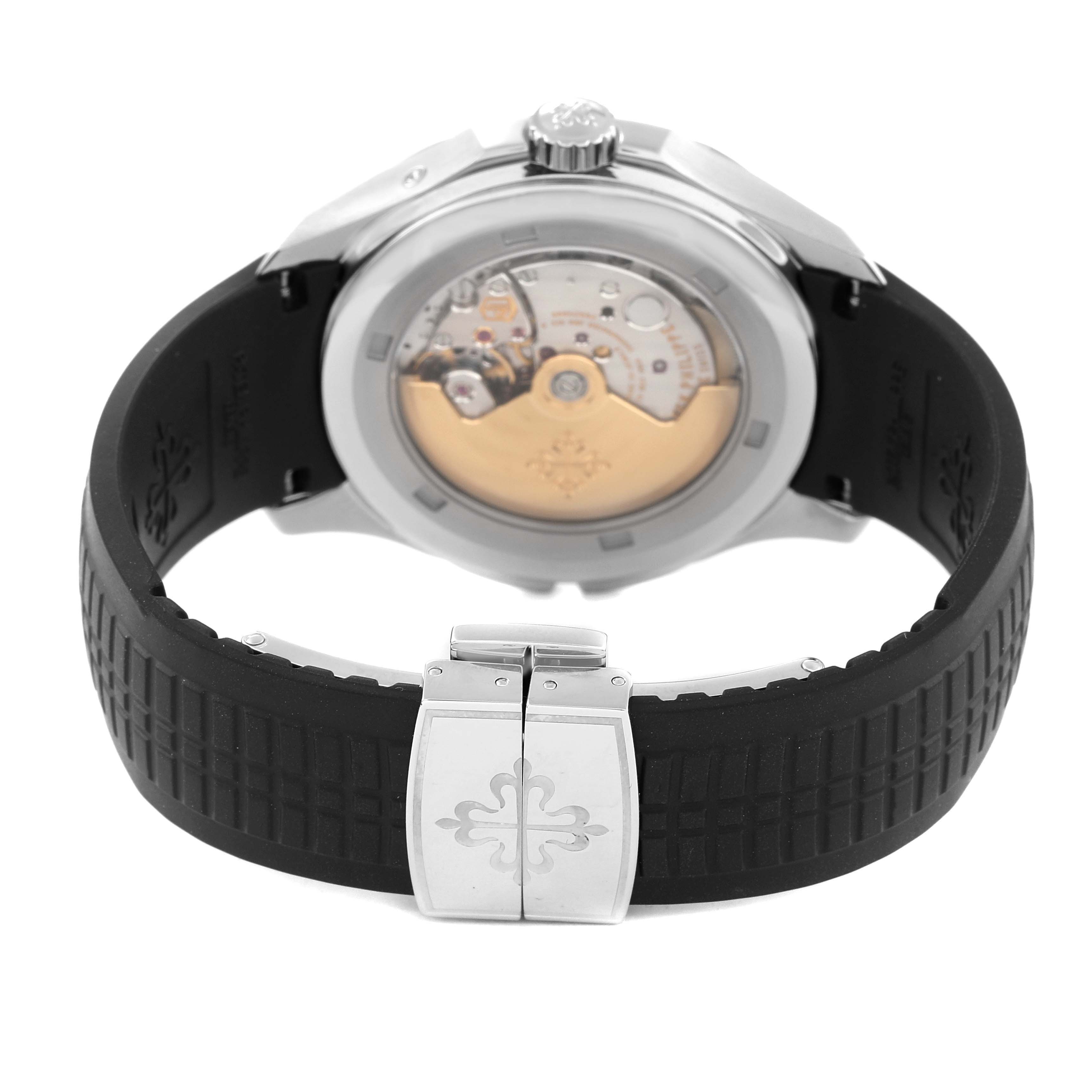 The image shows the back view of a Patek Philippe Aquanaut 5164 Men's Stainless Steel Black Dial 5164 Men's Stainless Steel Black Dial watch, highlighting the movement and the deployant clasp on the rubber strap.
