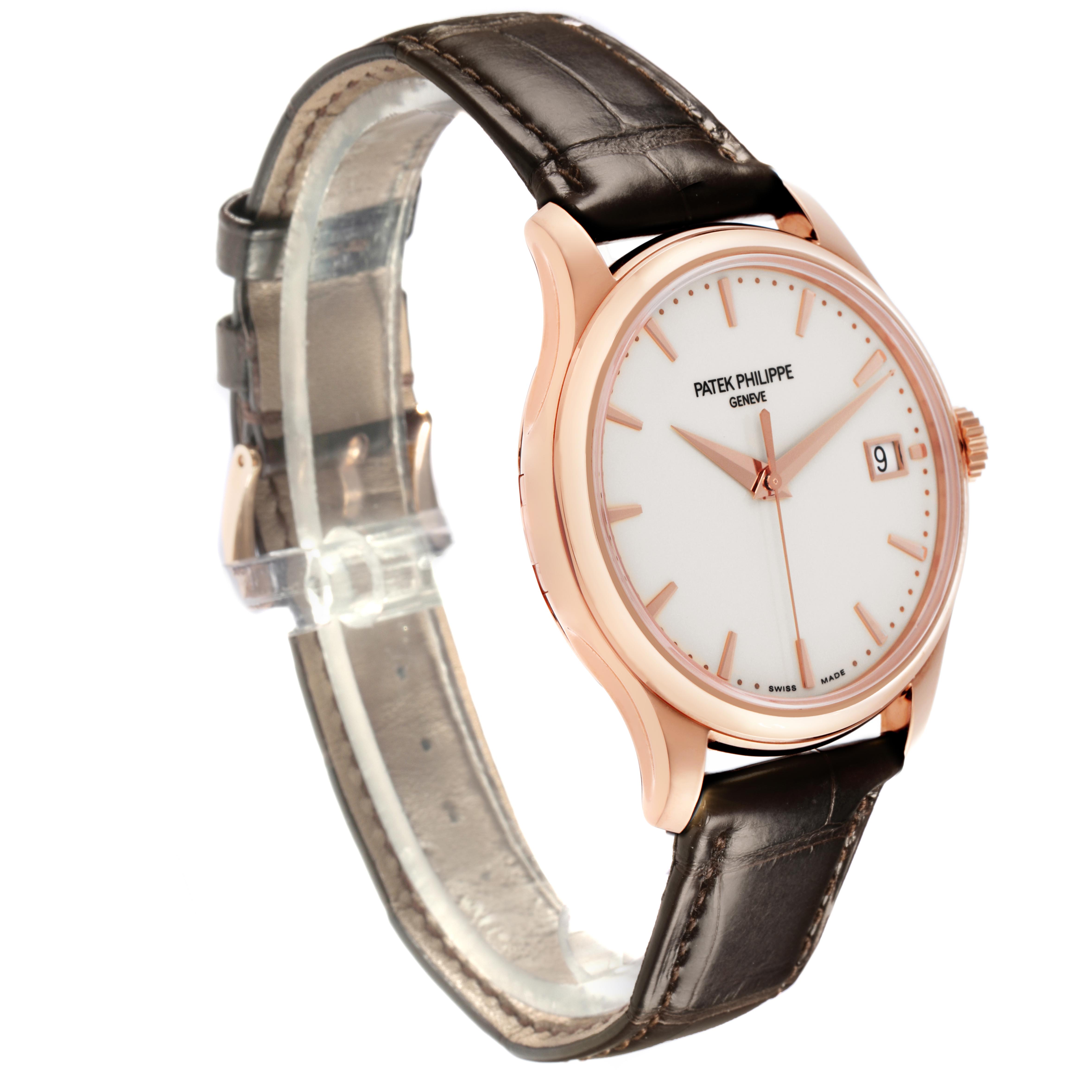 The Patek Philippe Calatrava 5227R-001 Men's Rose Gold White Dial 5227R-001 Men's Rose Gold White Dial watch is shown at a side angle, highlighting the rose gold case, dial, hands, markers, and leather strap.