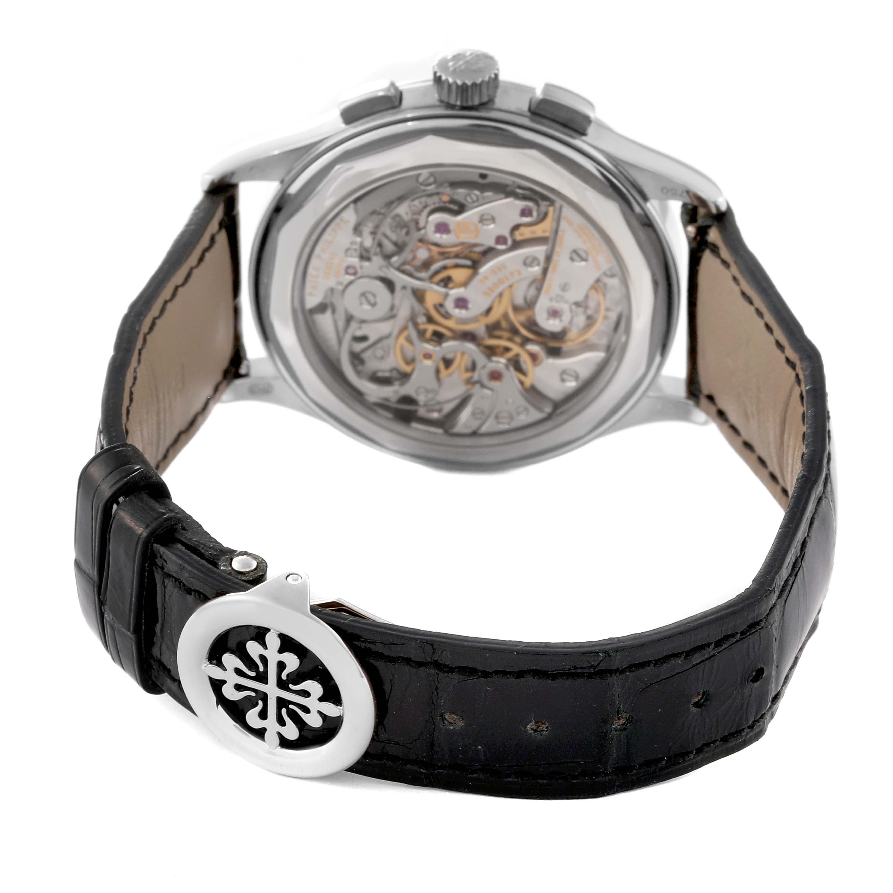 The image shows the back view of a Patek Philippe Complications 5170G-001 Men's White Gold Silver Dial 5170G-001 Men's White Gold Silver Dial model watch, highlighting its intricate movement and leather strap.