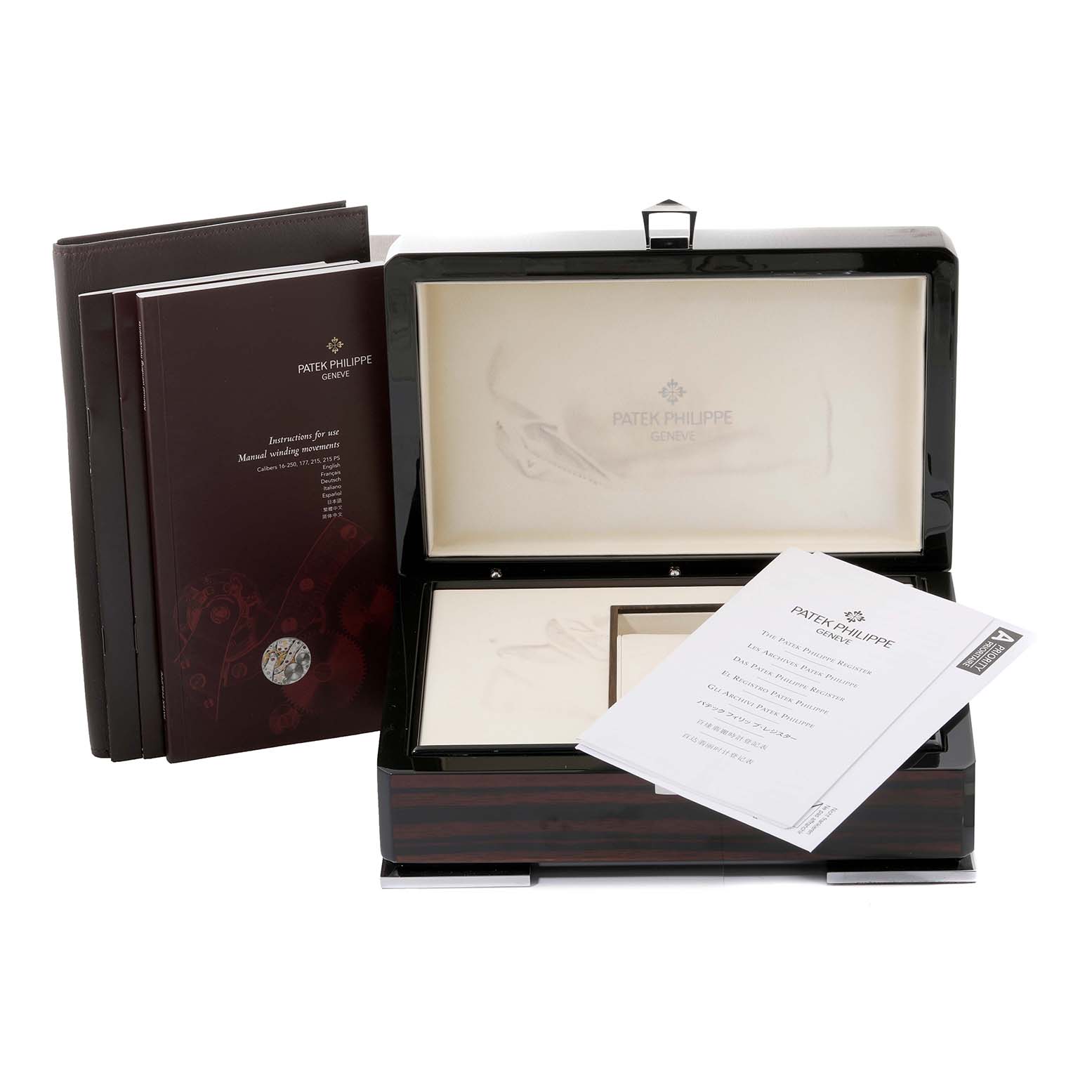 The image shows a Patek Philippe Complications 5170J Men
s Yellow Gold Silver Dial 5170J Men
s Yellow Gold Silver Dial watch box, instruction booklets, and accompanying documentation from a front angle.