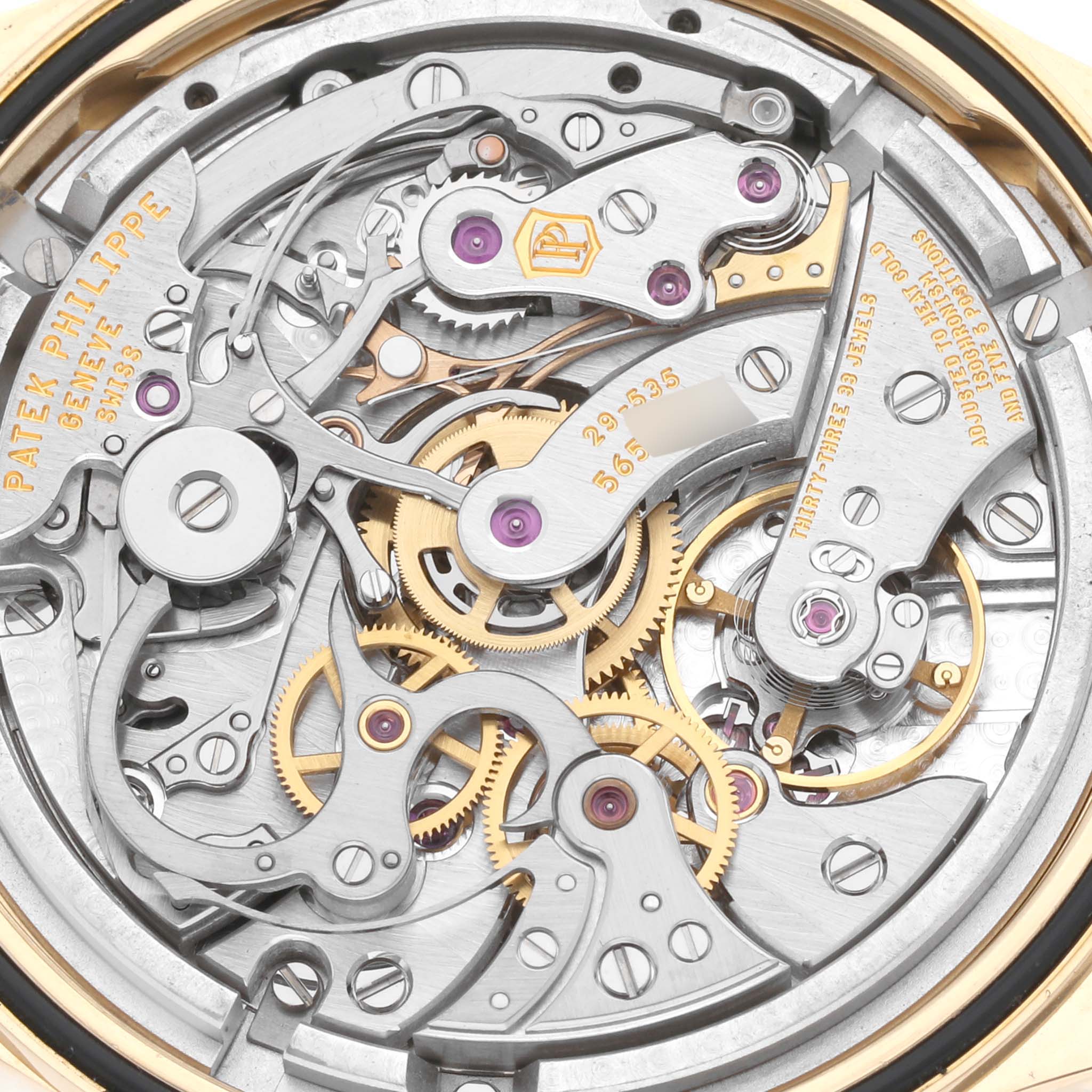 The image shows a close-up of the intricate mechanical movement of a Patek Philippe Complications 5170J Men
s Yellow Gold Silver Dial 5170J Men
s Yellow Gold Silver Dial model watch.