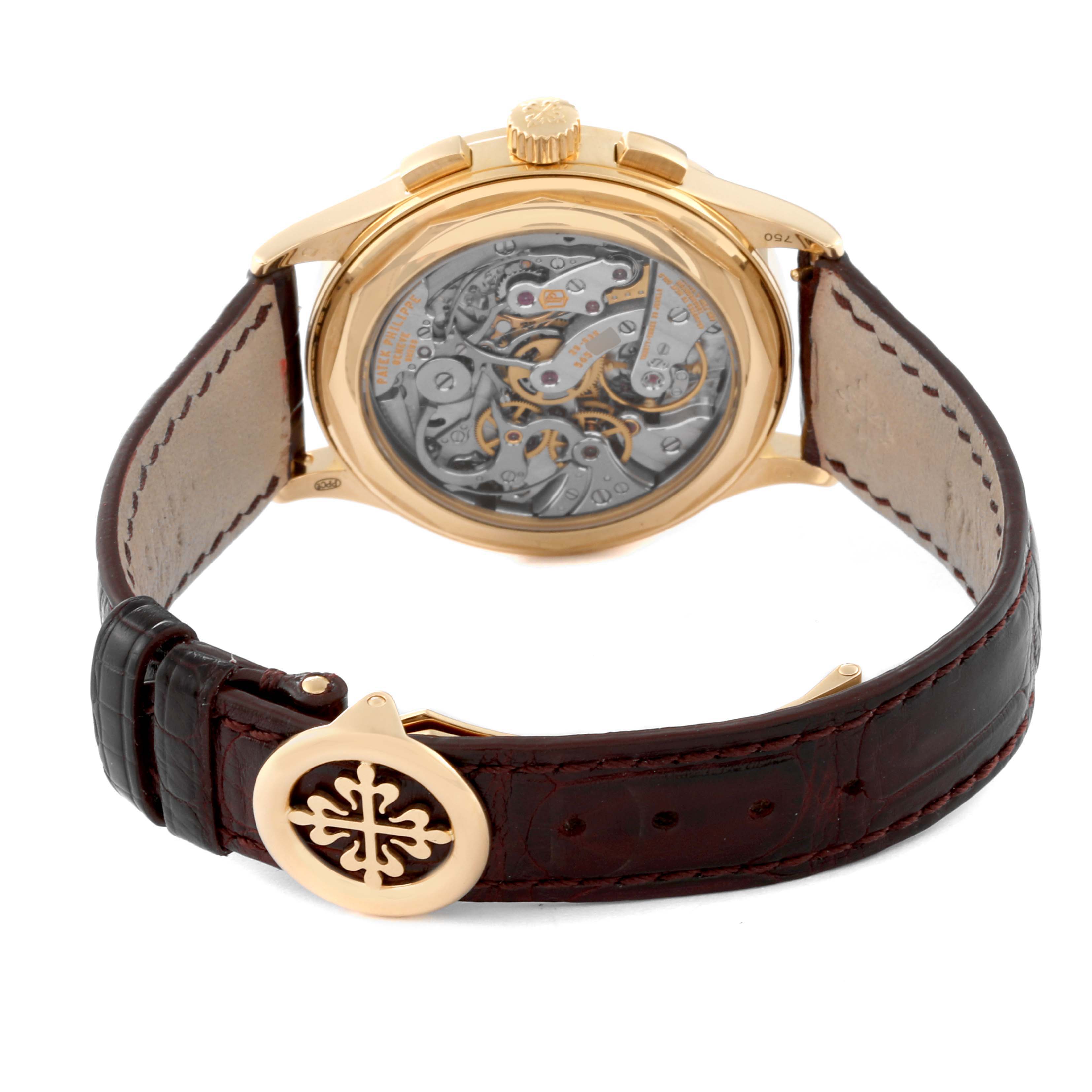 This image shows the back view of a Patek Philippe Complications 5170J Men
s Yellow Gold Silver Dial 5170J Men
s Yellow Gold Silver Dial watch, highlighting its intricate movement and leather strap.