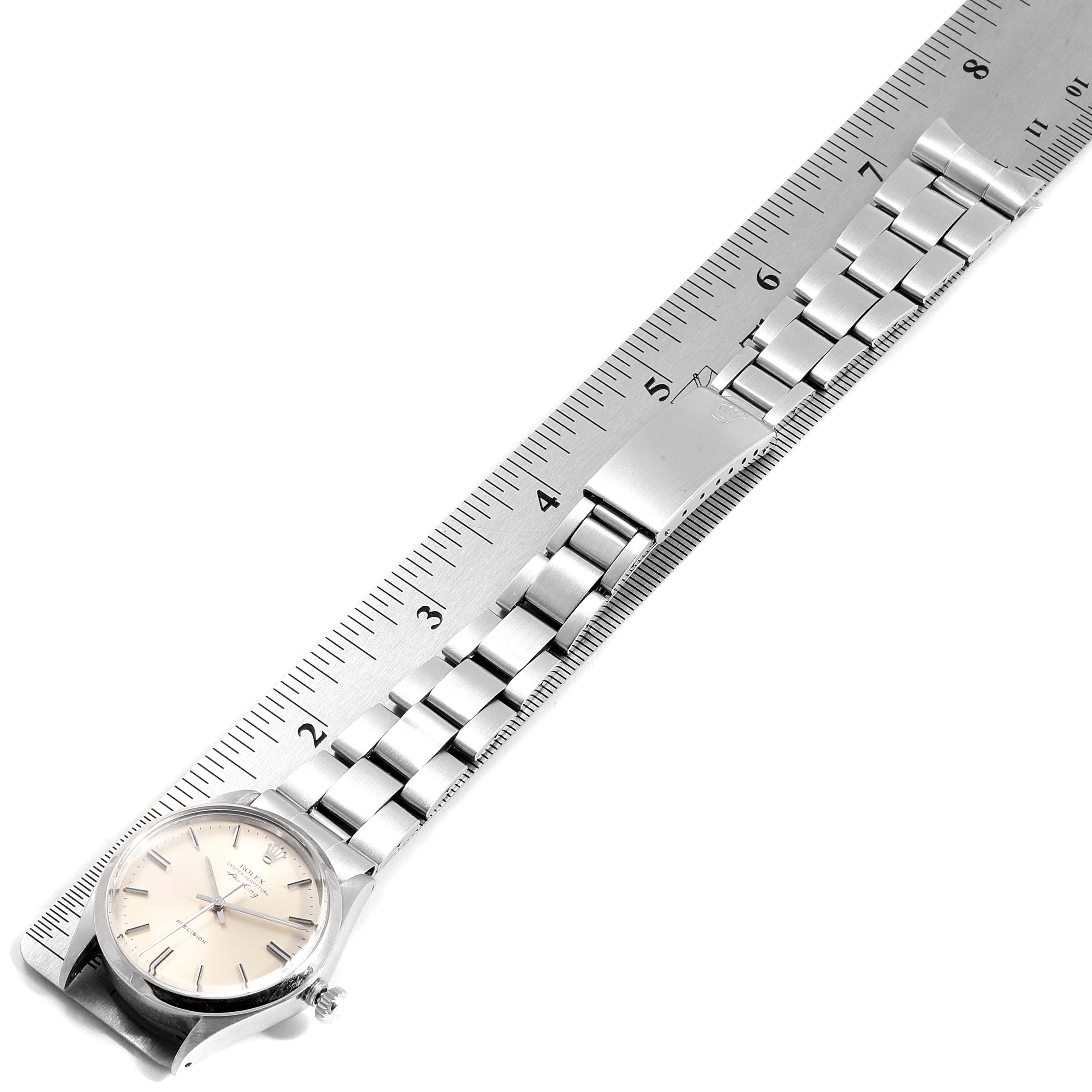 The image shows the Rolex Vintage Collection 5500 Men's Stainless Steel Silver Dial 5500 Men's Stainless Steel Silver Dial watch laid flat, measured against a ruler, displaying the face and full metal bracelet.
