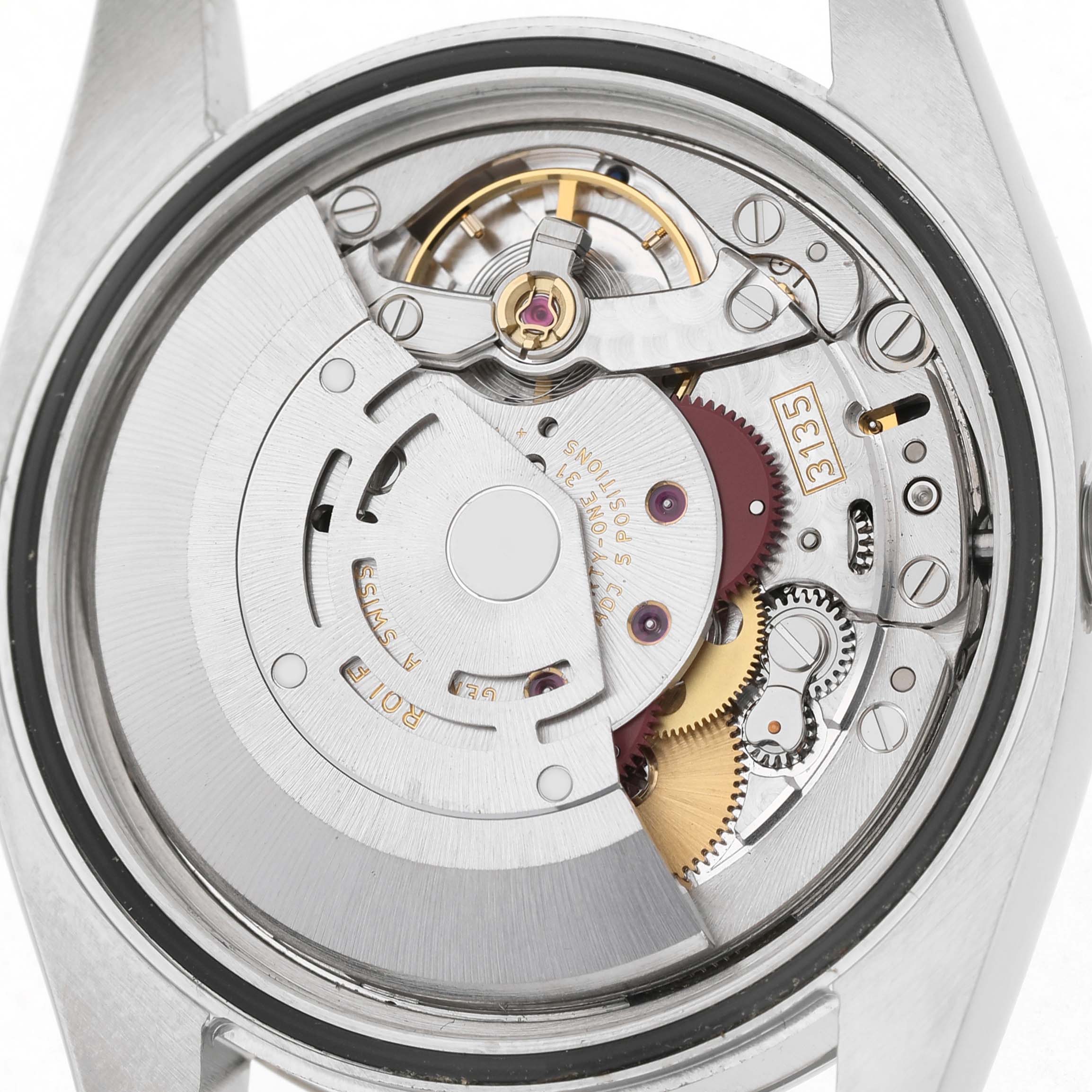 The image shows the movement mechanism of a Rolex Datejust 116234 Men's Stainless Steel Blue Dial watch from a back view, displaying gears and components.