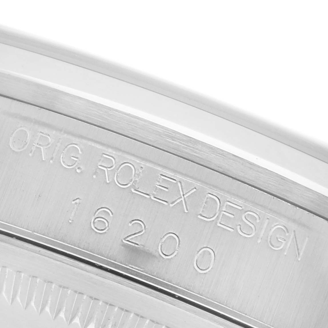 The image shows a close-up of the Rolex Datejust 16200 Men's Stainless Steel White Dial 16200 Men's Stainless Steel White Dial model's case with engraving details and reference number.