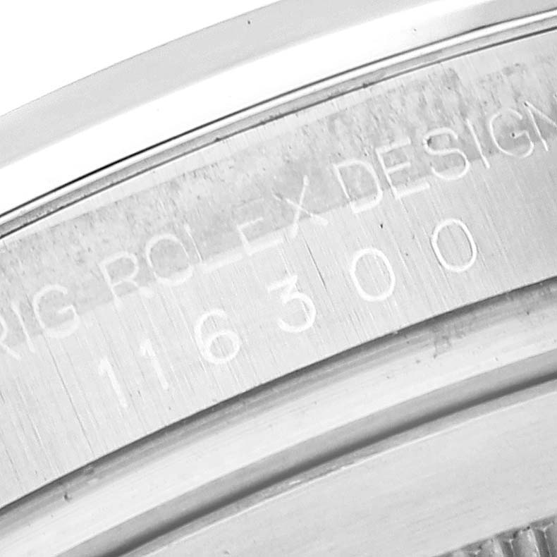 The image shows a close-up angle of the Rolex Datejust 116300 Men's Stainless Steel White Dial model's engraved inner bezel with model number and design details.