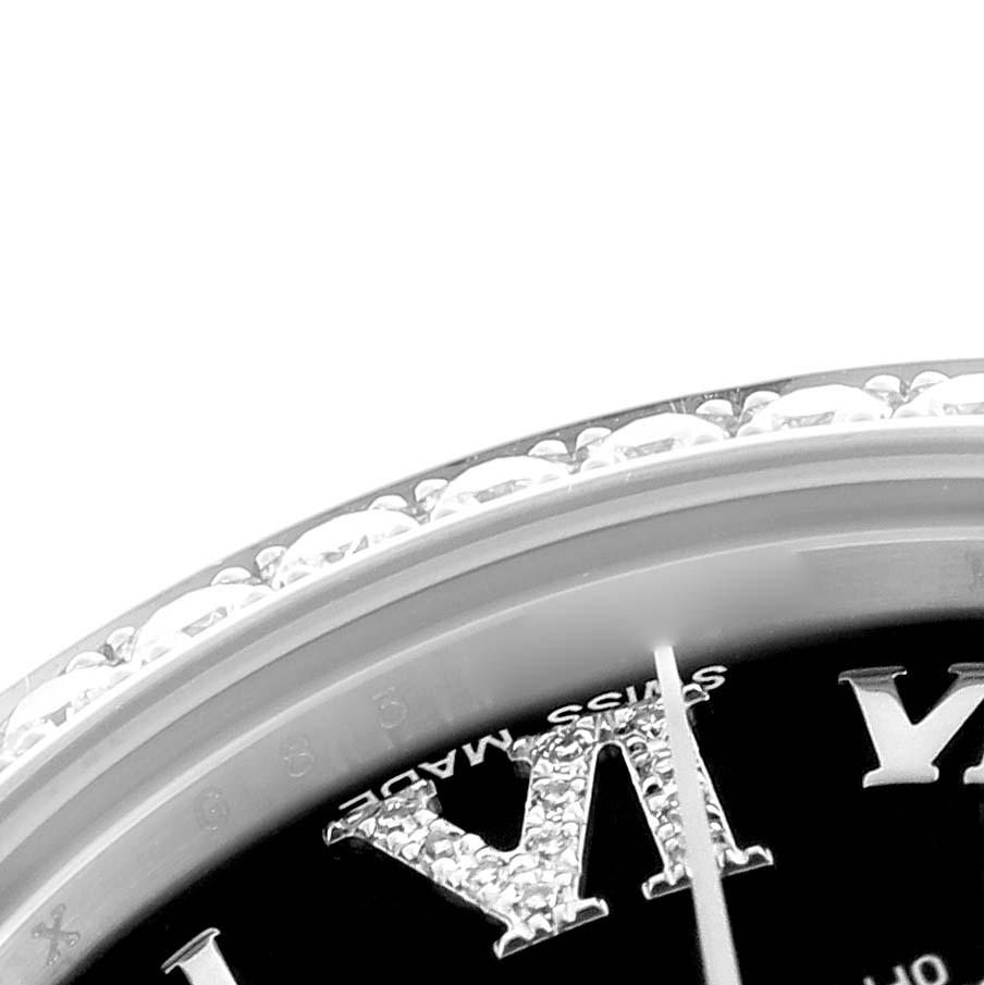 This image shows a close-up of a Rolex Mid-Size 178384 Women's Stainless Steel Black Dial 178384 Women's Stainless Steel Black Dial watch, highlighting the bejeweled bezel and part of the dial with Roman numerals.