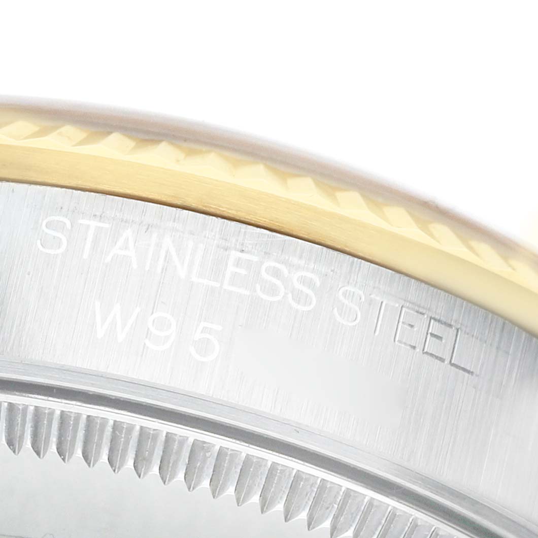 The image shows the engraved side of the stainless steel case and fluted bezel of a Rolex Datejust 68273 Women's Stainless Steel Champagne Dial watch.