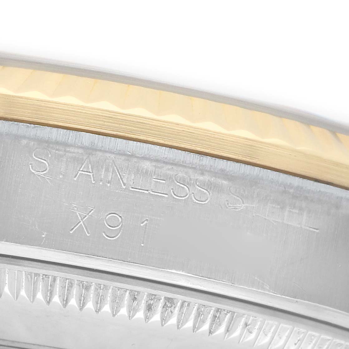 The image shows a close-up of the engraved bezel and side of a stainless steel and gold Rolex Mid-Size 68273 Women's Steel and Gold (two tone) Beige Dial watch.