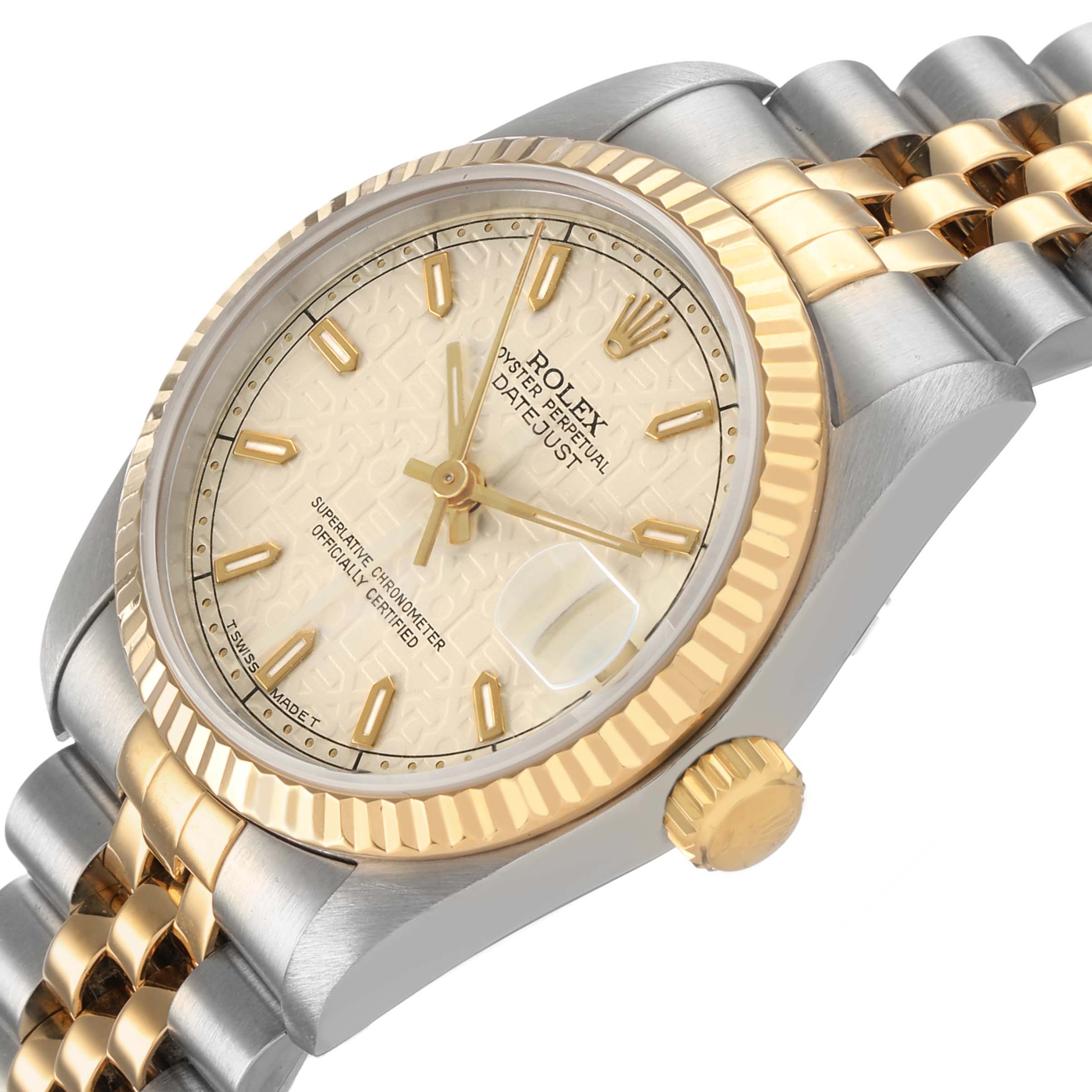 The Rolex Mid-Size 68273 Women's Steel and Gold (two tone) Beige Dial watch is shown at an angled top view, highlighting the face, fluted bezel, crown, and part of the bracelet.