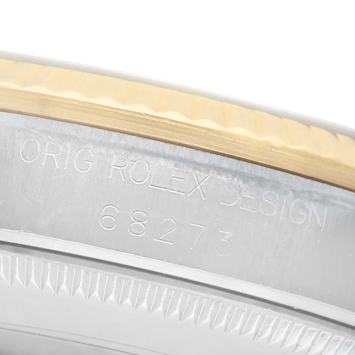The image shows the side of a Rolex Mid-Size 68273 Women's Steel and Gold (two tone) Beige Dial model, highlighting the bezel and engraved reference number.