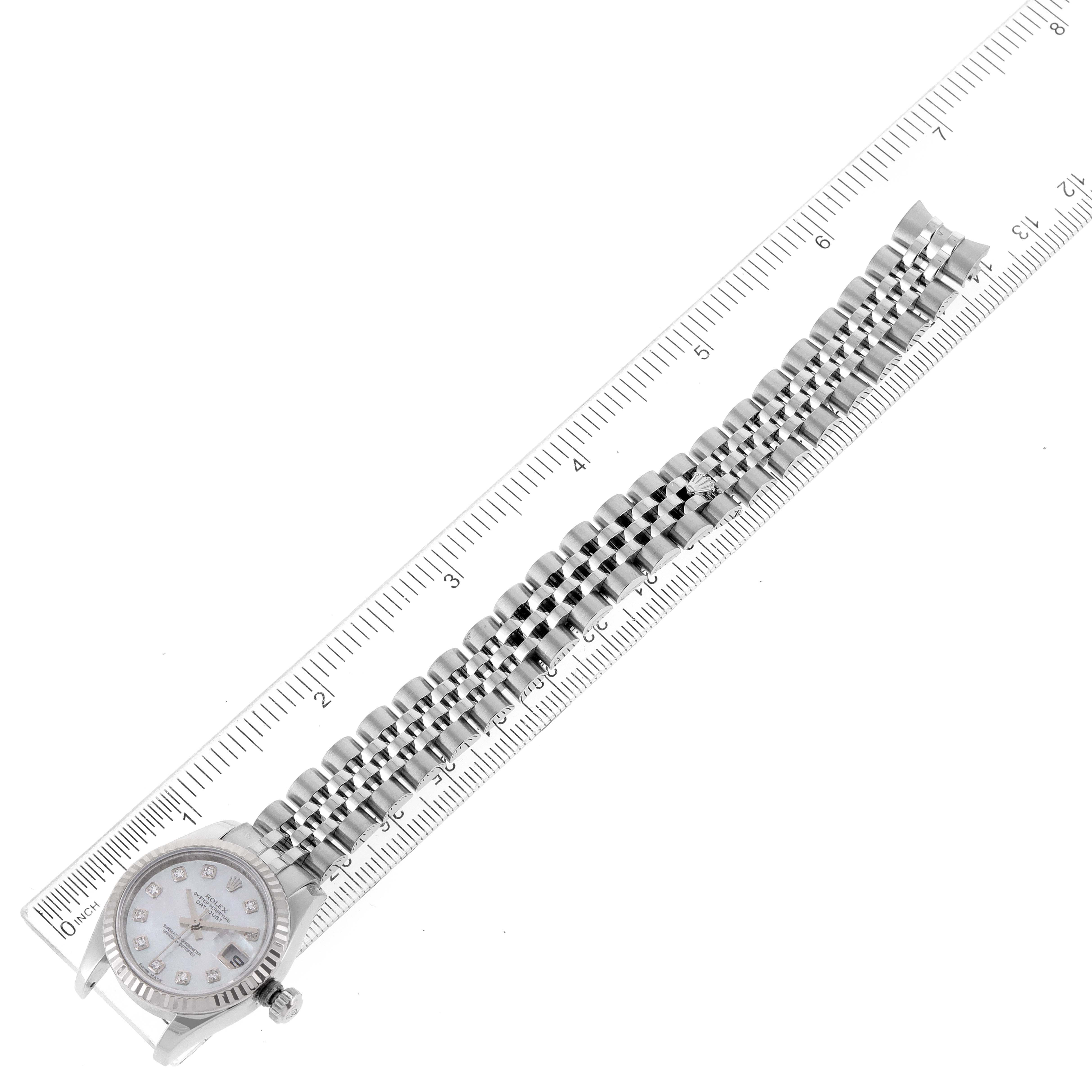 The image shows a top-down view of a Rolex Datejust 179174 Women's Stainless Steel Mother of Pearl Dial 179174 Women's Stainless Steel Mother of Pearl Dial watch placed on a ruler, highlighting the case and the full bracelet.