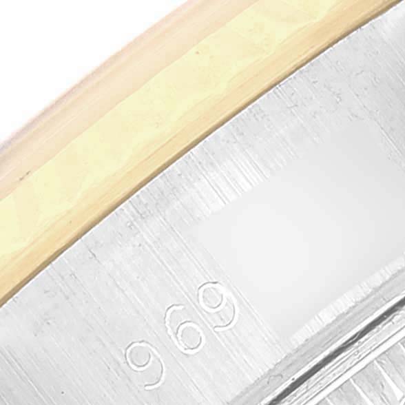 The image shows a close-up angle of the Rolex Datejust 69173 Women's Steel and Gold (two tone) Champagne Dial model's bezel and edge of the case, highlighting the metal texture and engraving "969."