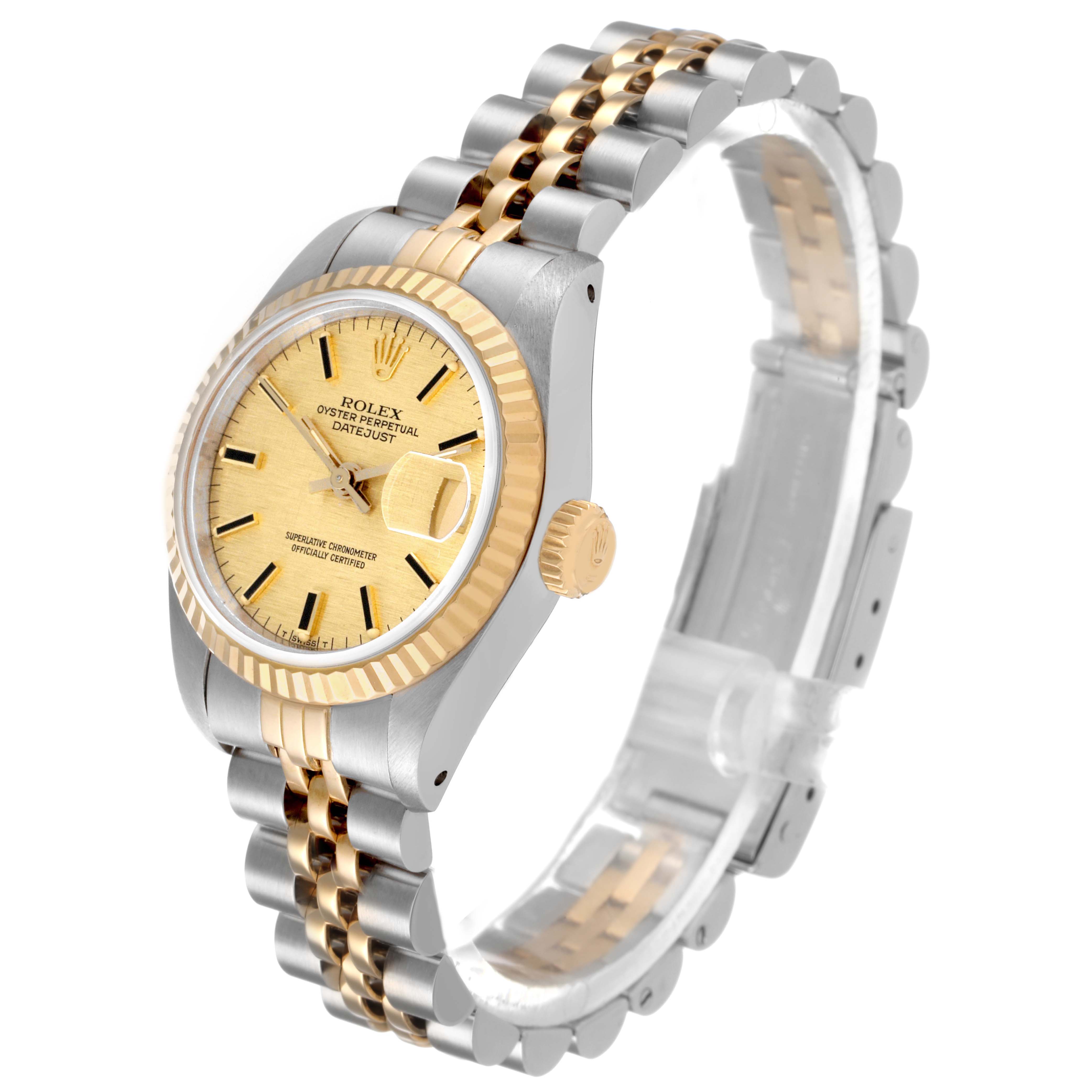 The Rolex Datejust 69173 Women's Steel and Gold (two tone) Champagne Dial watch is shown at a three-quarter angle highlighting the gold dial, fluted bezel, and two-tone bracelet.