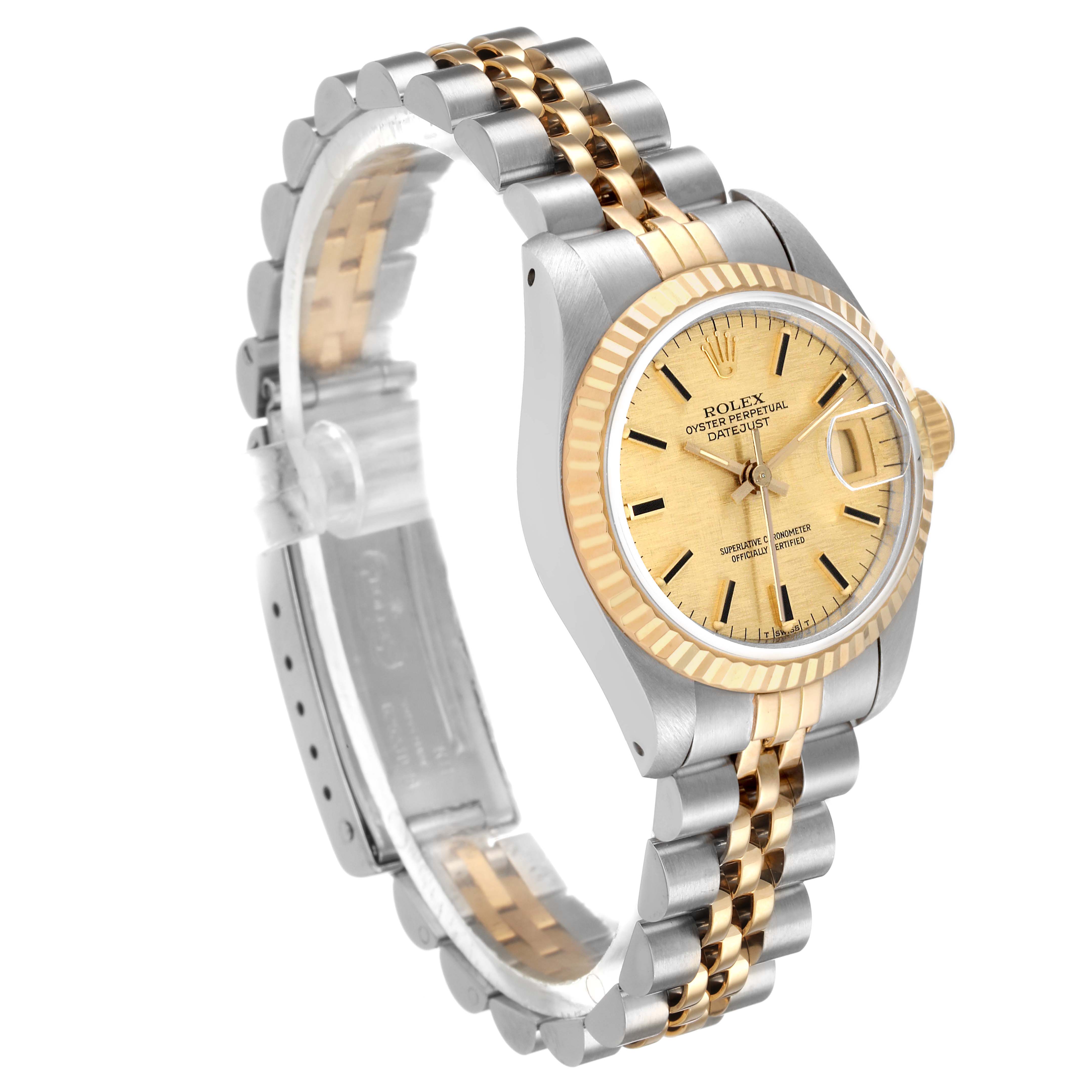 The Rolex Datejust 69173 Women's Steel and Gold (two tone) Champagne Dial watch is shown at a three-quarters angle, displaying the case, fluted bezel, bracelet, and partial dial.