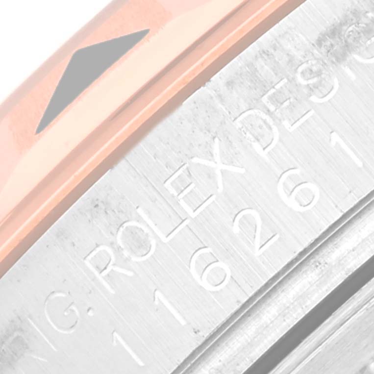 This close-up image of the Rolex Turn-o-Graph 116261 Men
s Steel and Gold (two tone) White Dial 116261 Men
s Steel and Gold (two tone) White Dial model shows part of the bezel and engraved text on the case.