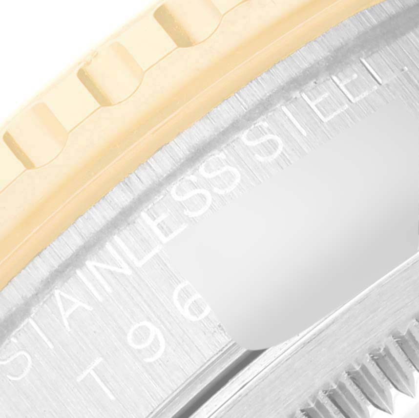 This close-up image of a Rolex Turn-o-Graph 16263 Men's Steel and Gold (two tone) Beige Dial 16263 Men's Steel and Gold (two tone) Beige Dial model shows part of the bezel and the stainless steel engravings.