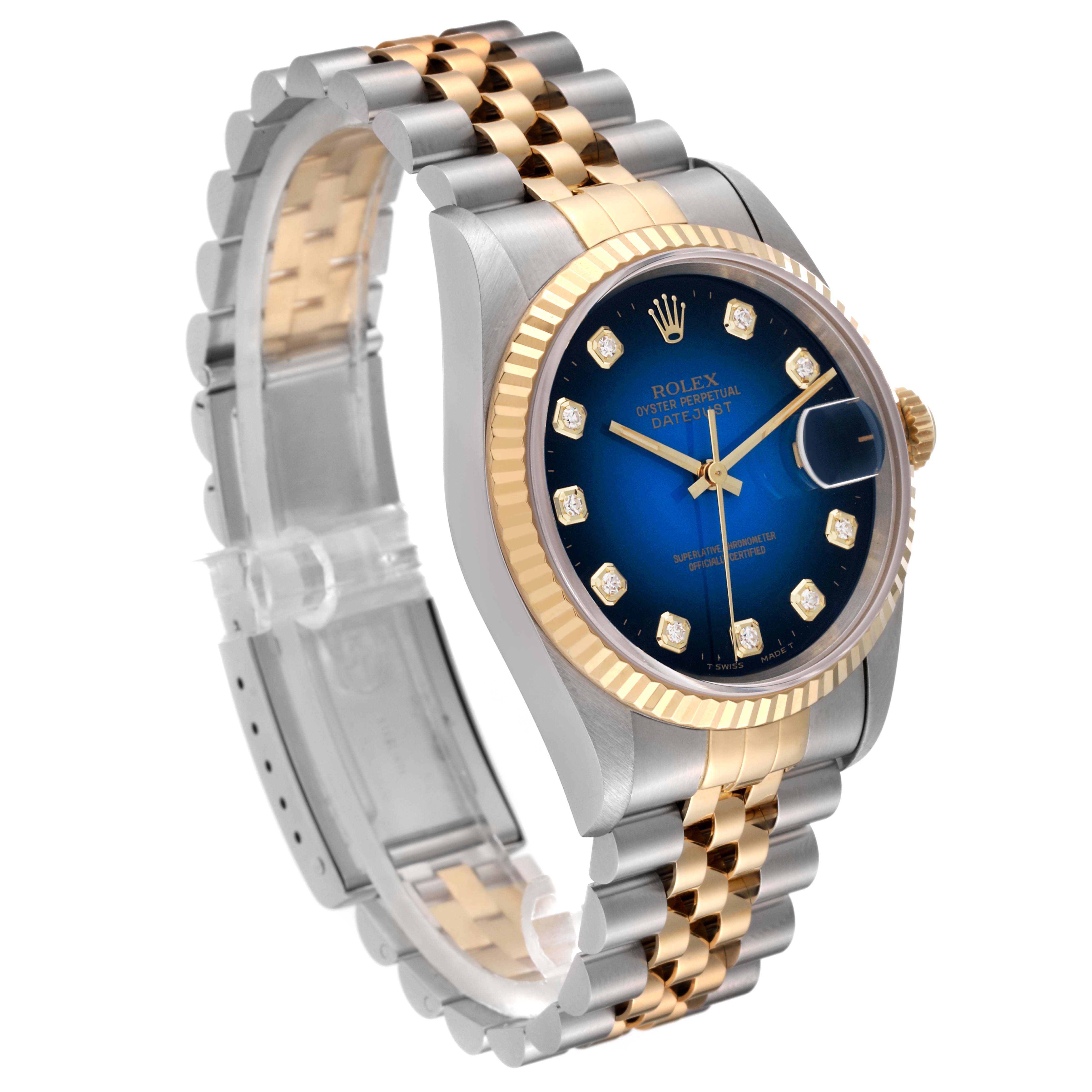 This image shows a Rolex Datejust 16233 Men's Steel and Gold (two tone) Blue Dial 16233 Men's Steel and Gold (two tone) Blue Dial watch at an angle, highlighting its two-tone bracelet, fluted bezel, and blue dial.