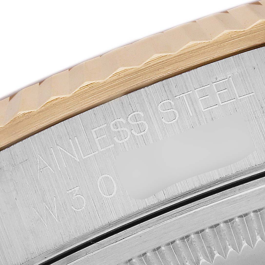 The image focuses on the side of the Rolex Datejust 16233 Men's Steel and Gold (two tone) Blue Dial 16233 Men's Steel and Gold (two tone) Blue Dial watch case, showing stainless steel and part of the fluted bezel.