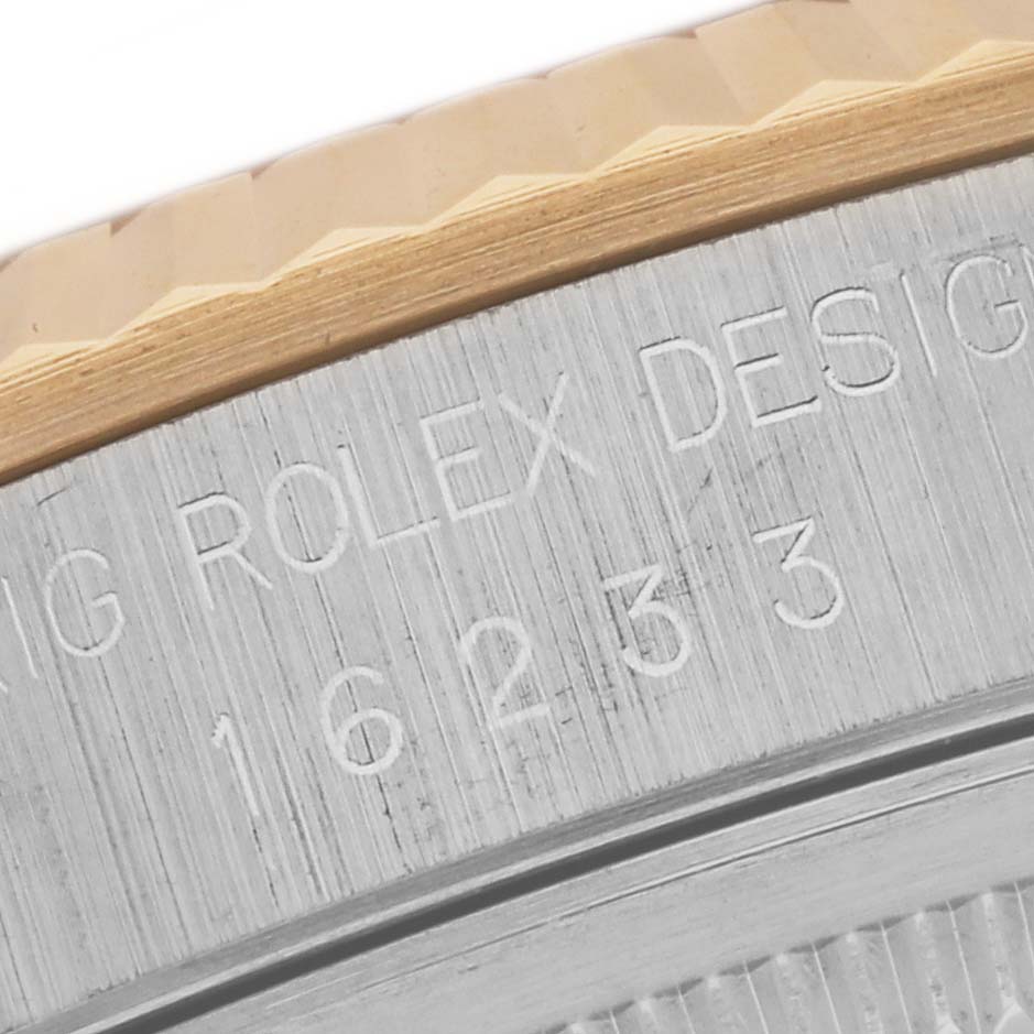 This image shows a close-up of the case side of the Rolex Datejust 16233 Men's Steel and Gold (two tone) Blue Dial 16233 Men's Steel and Gold (two tone) Blue Dial, featuring the model number and part of the fluted bezel.