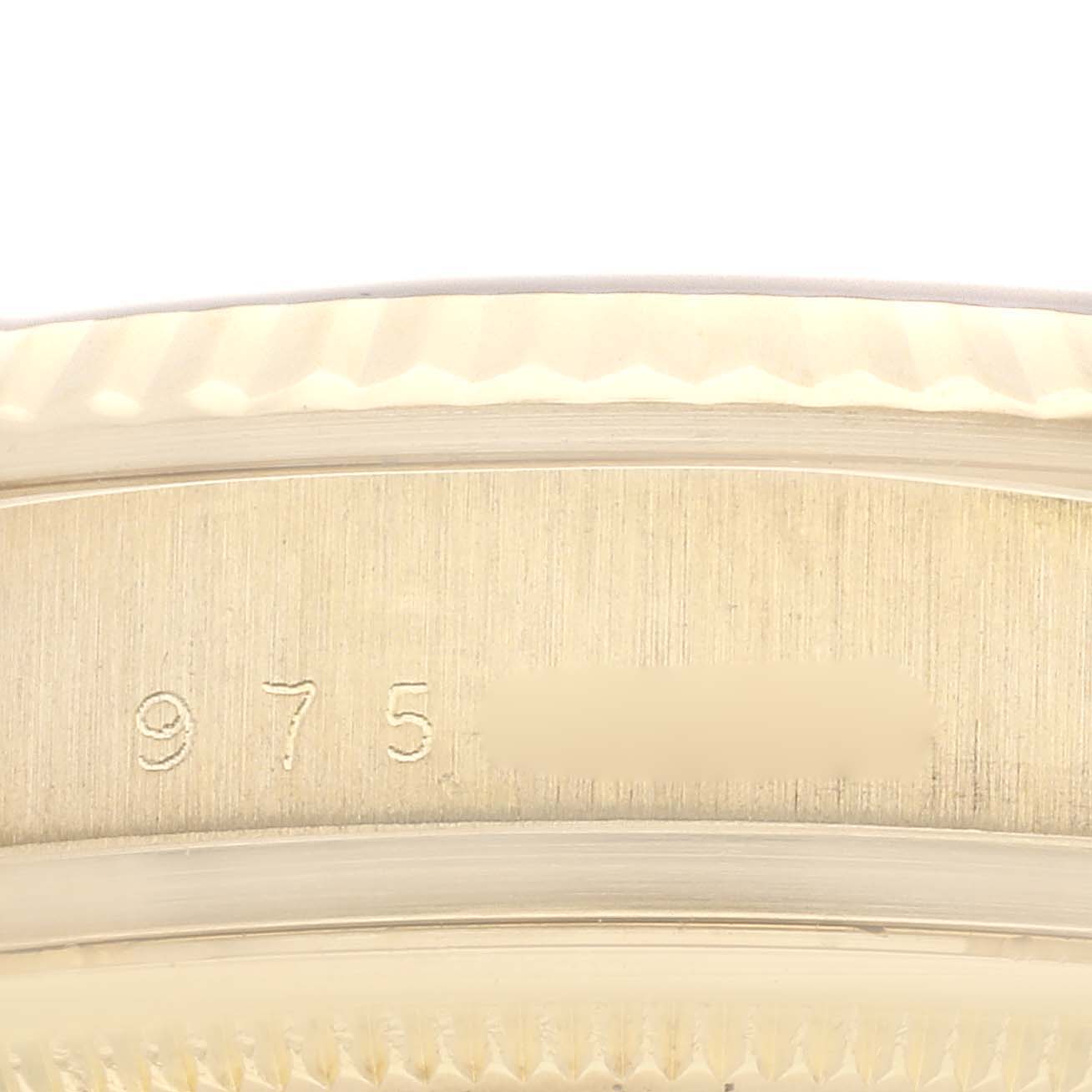 The image shows a close-up of the engraved serial number on the bezel of a Rolex Vintage Collection watch.