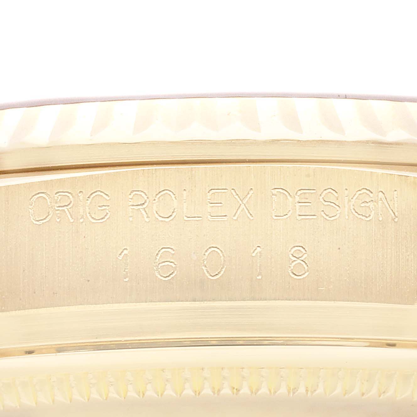 The image shows a close-up of the edge of a Rolex Vintage Collection model, featuring the engraved design and model number 16018.