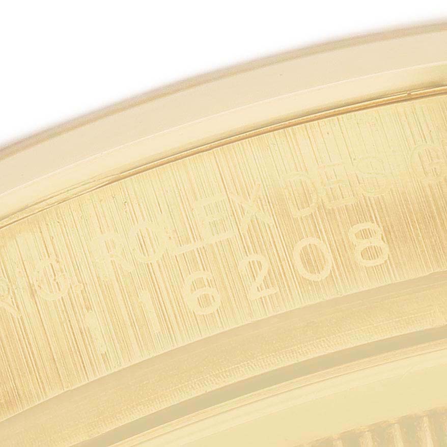 This image shows a close-up of the engraved bezel on a Rolex Datejust 116208 Men's Yellow Gold Champagne Dial watch.